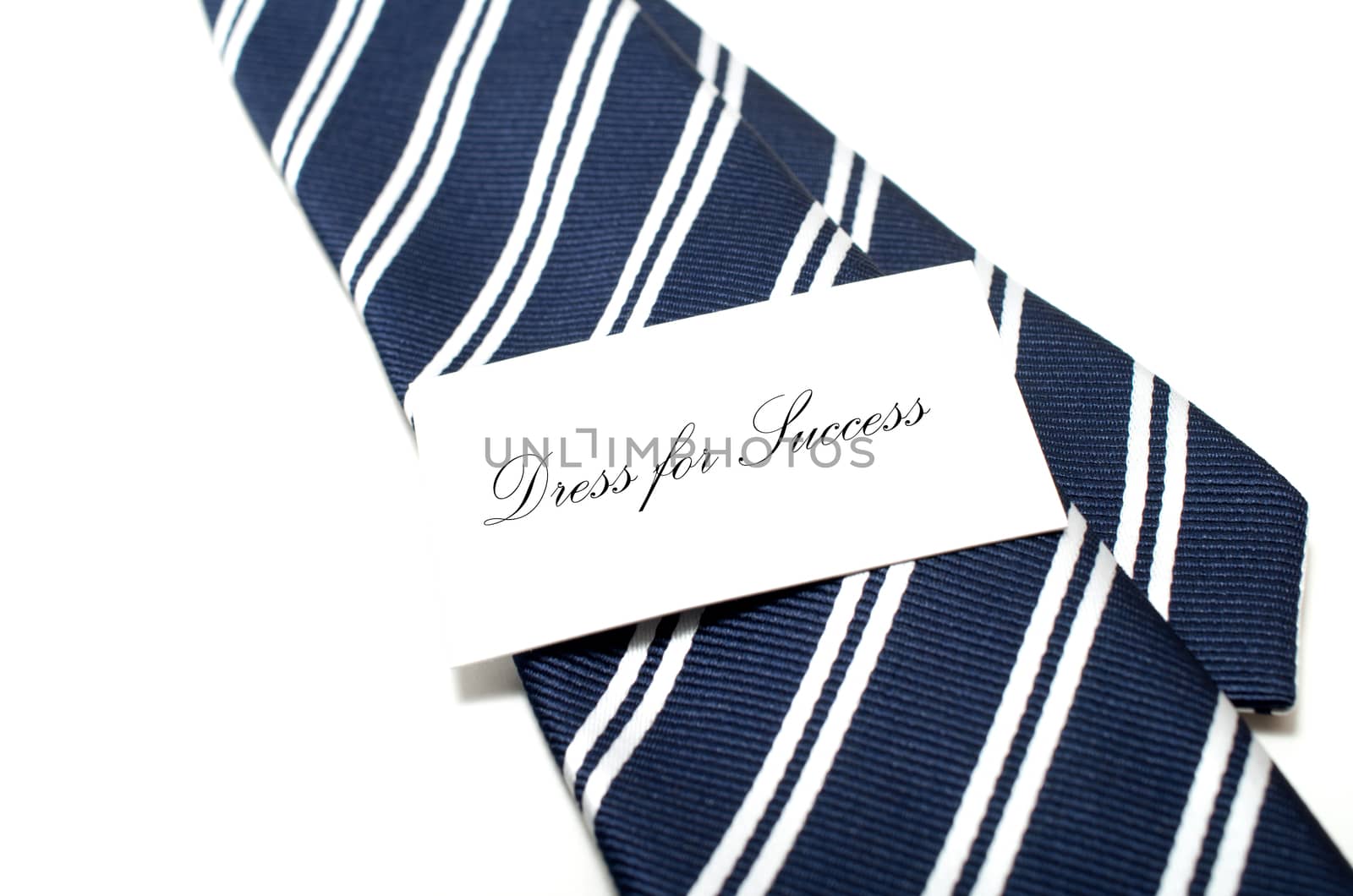 Dress for success tag on blue tie over white background