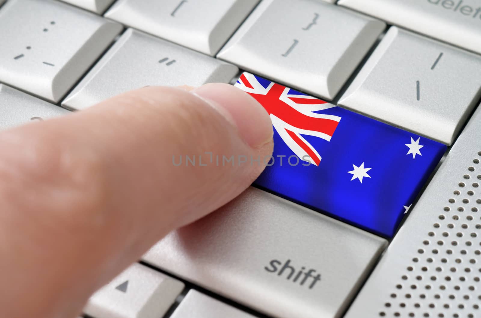 Business concept male finger pressing Australia enter key on metallic keyboard
