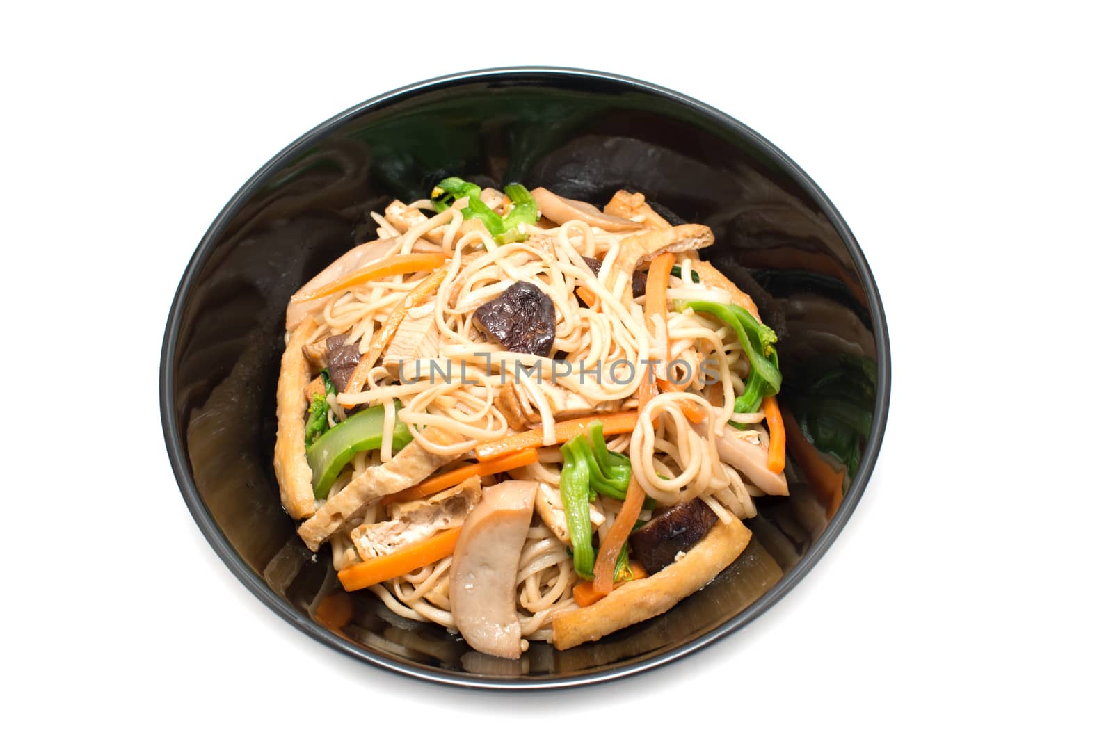 Vegetarian stir fry noodle plate on white background