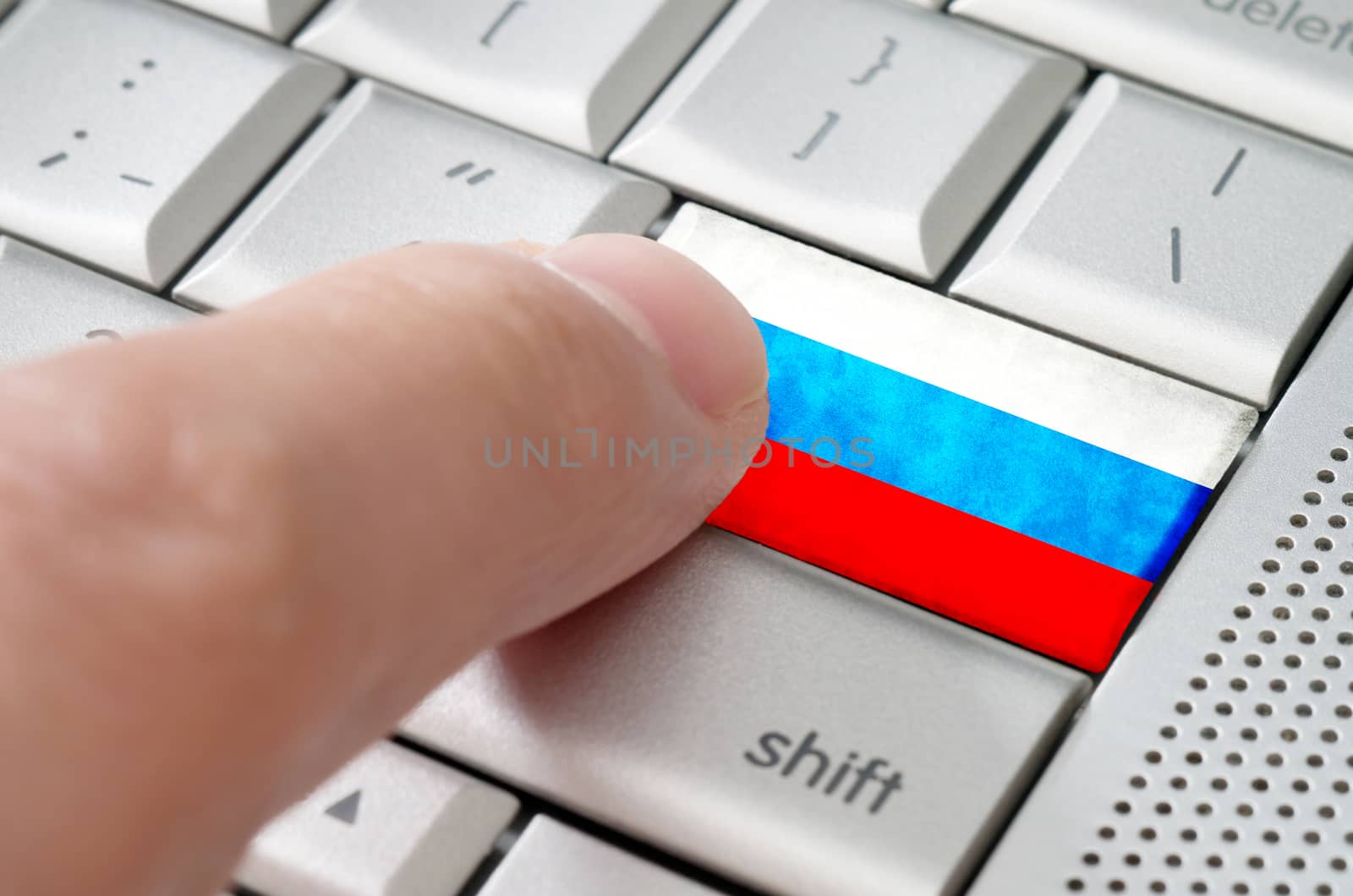 Business concept male finger pressing Russia enter key on metallic keyboard