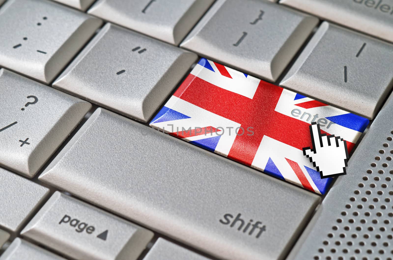 Business concept mouse cursor pressing United Kingdom enter key on metallic keyboard