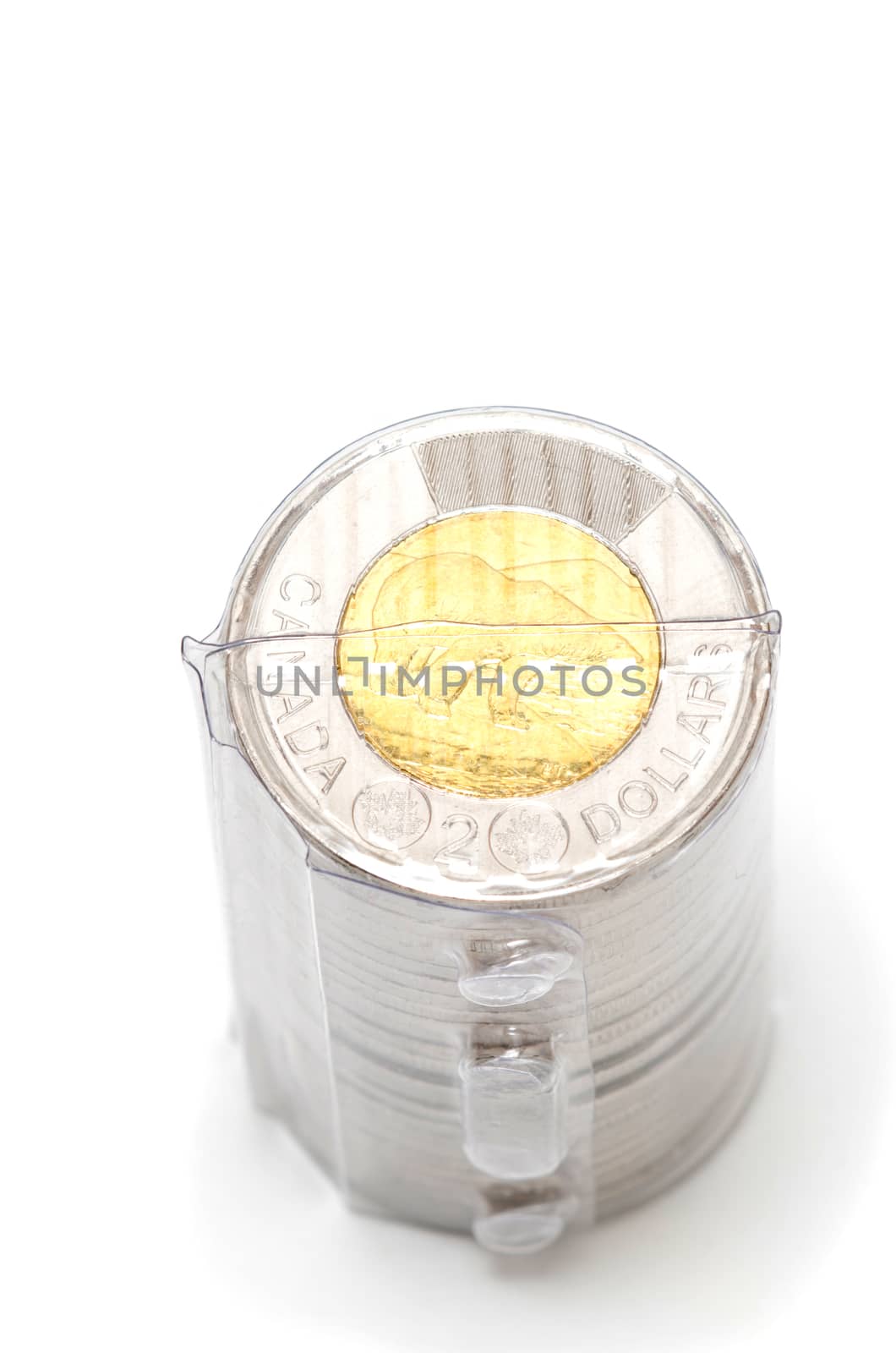 Plastic roll holding two dollar coins on white background