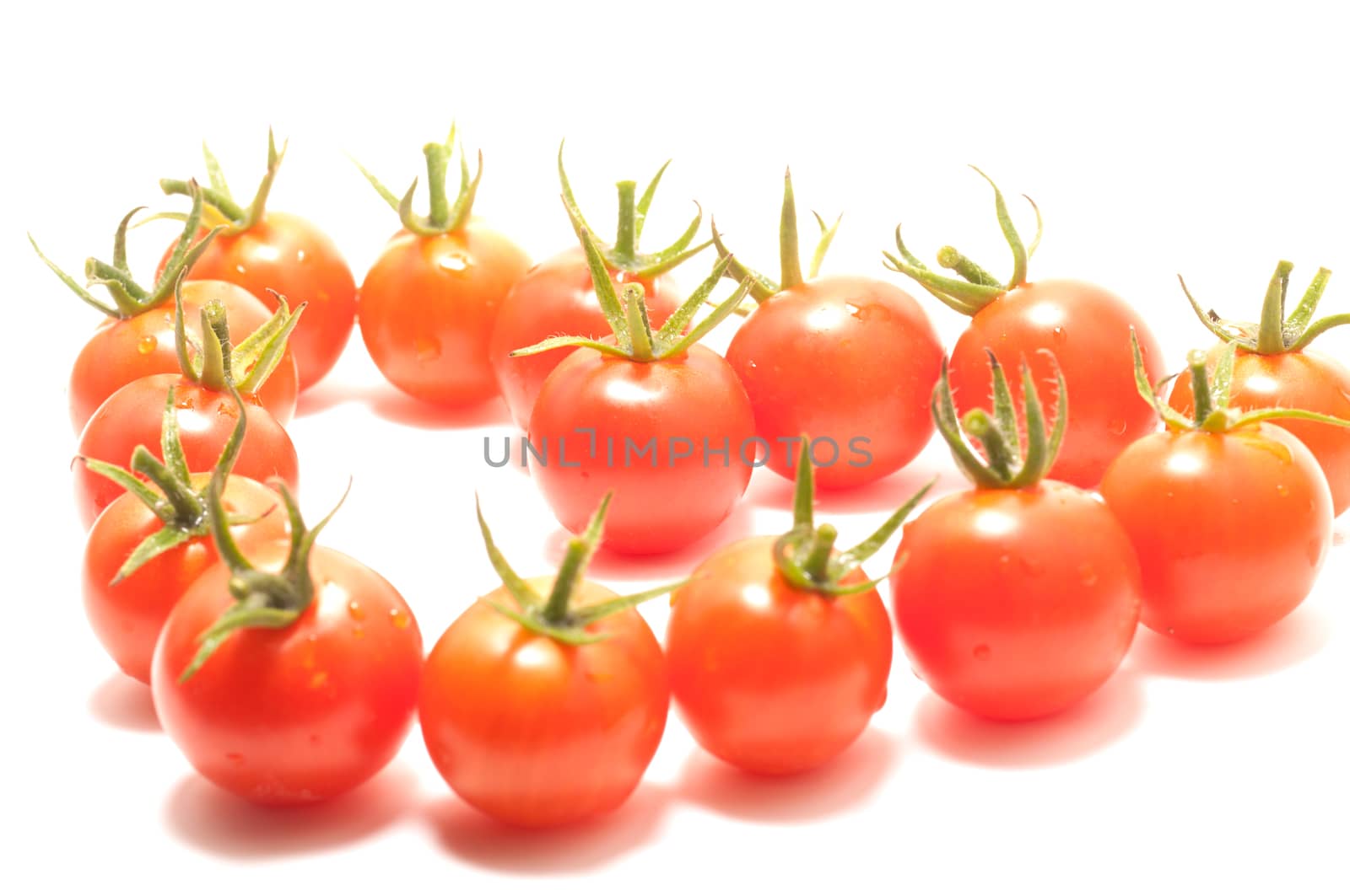 Cherry tomatoes heart shape on white background