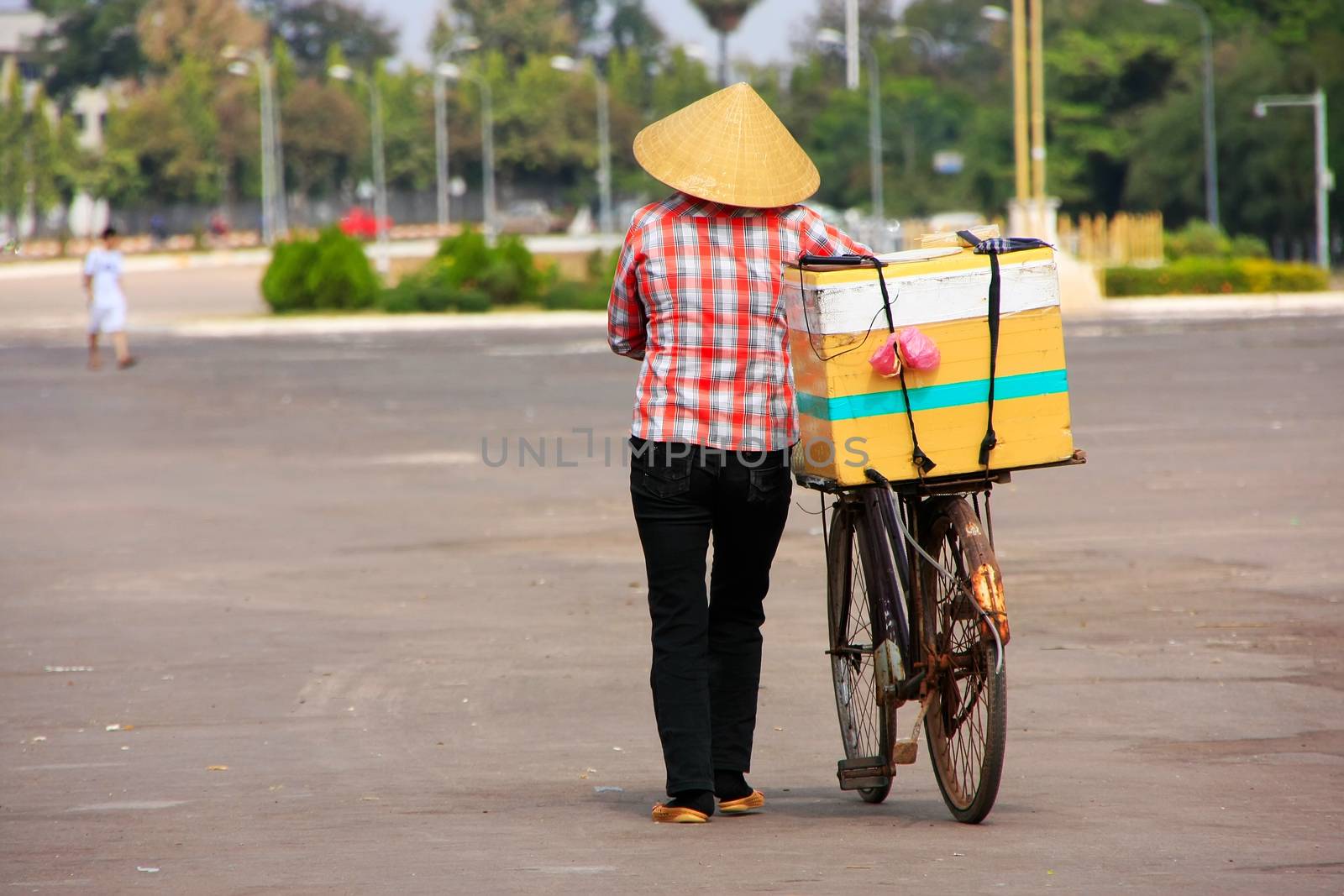 Local woman selling ice cream on the street, Vientiane, Laos by donya_nedomam