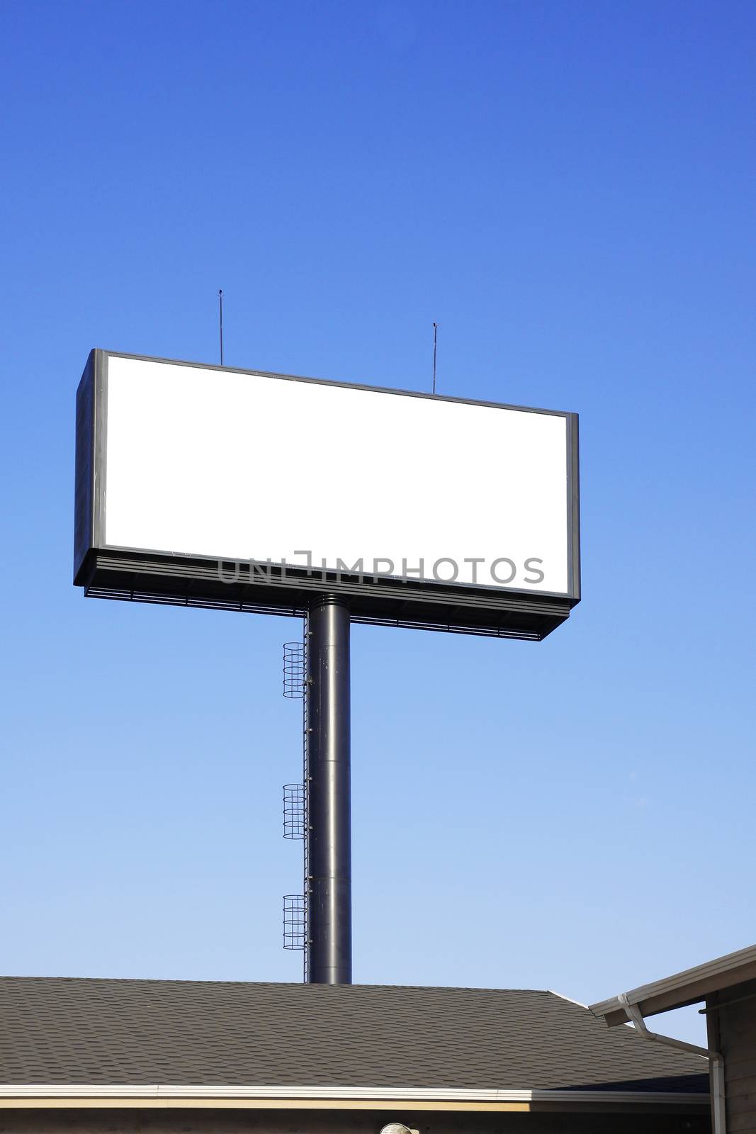 Blank billboard with space for your advertisement against blue sky