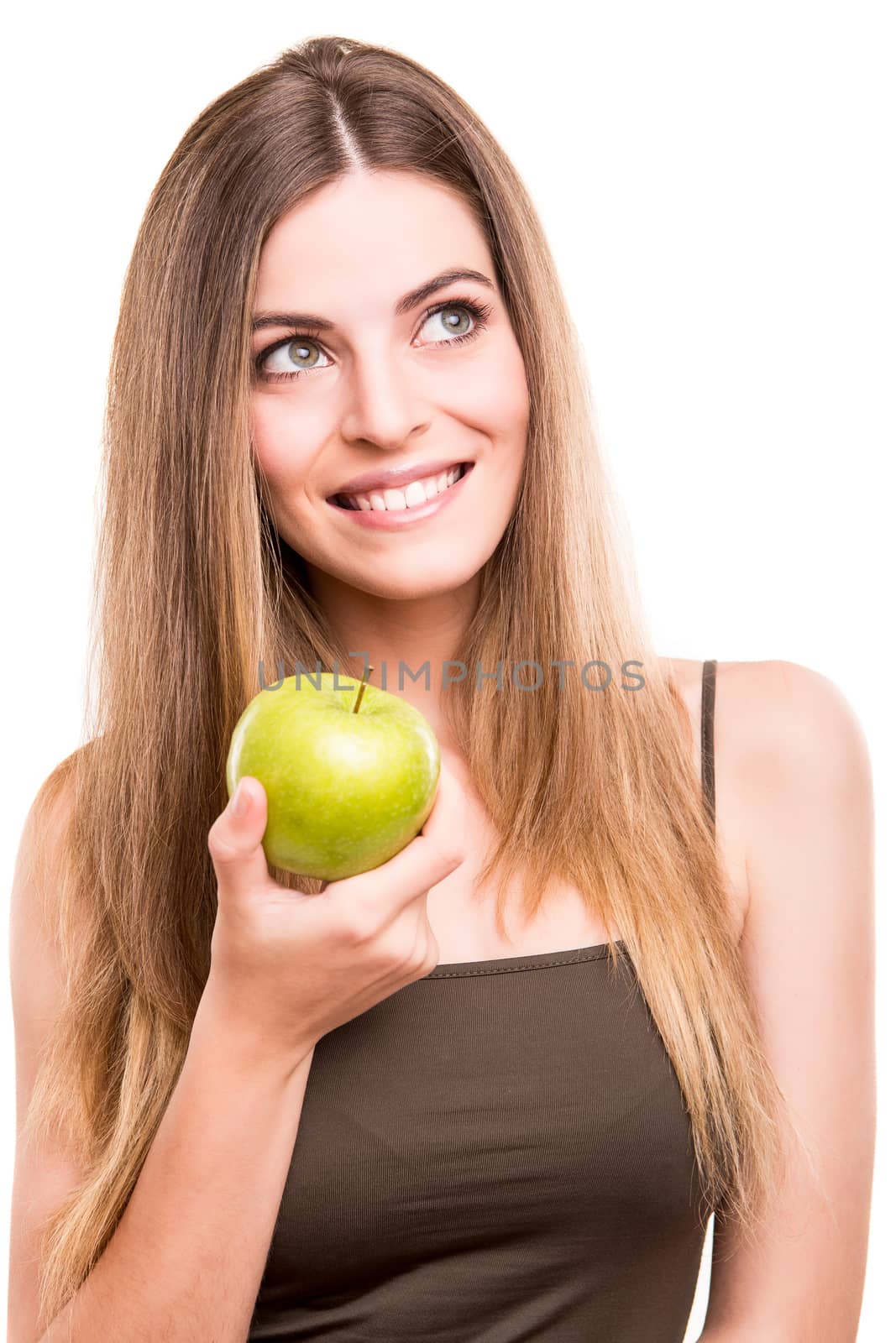 Portrait of a young woman eating green apple