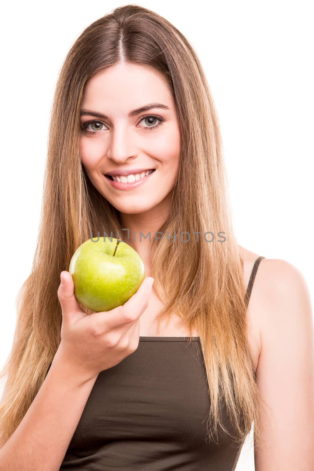 Portrait of a young woman eating green apple