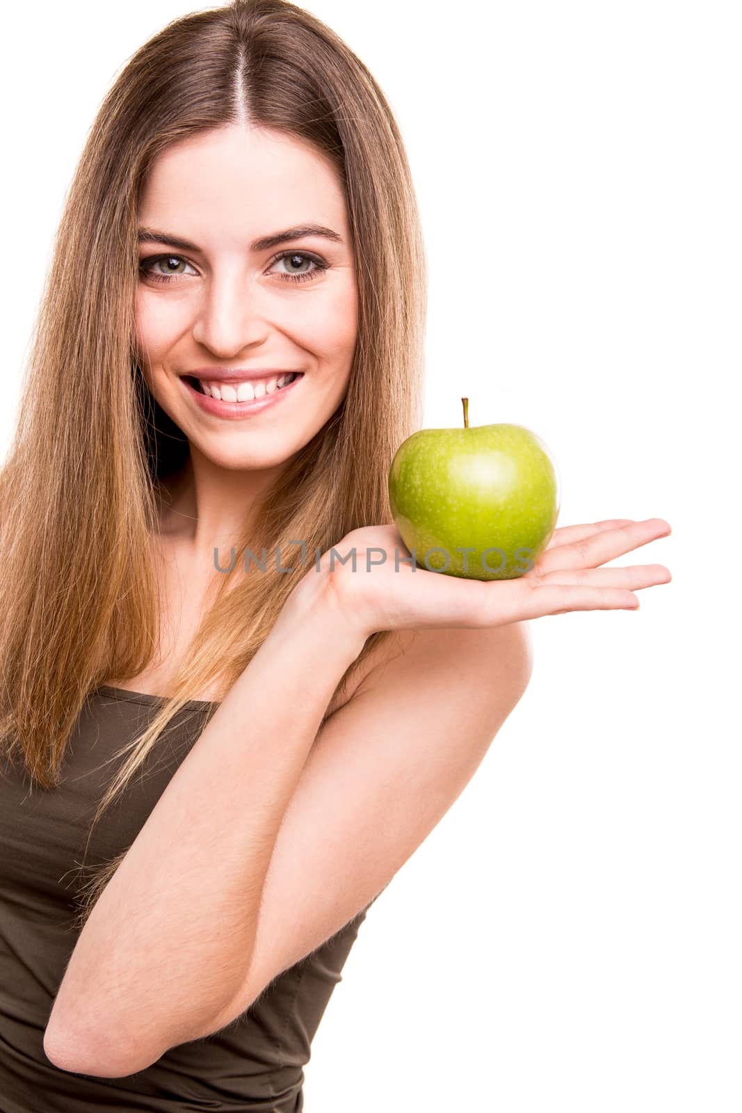 Portrait of a young woman eating green apple