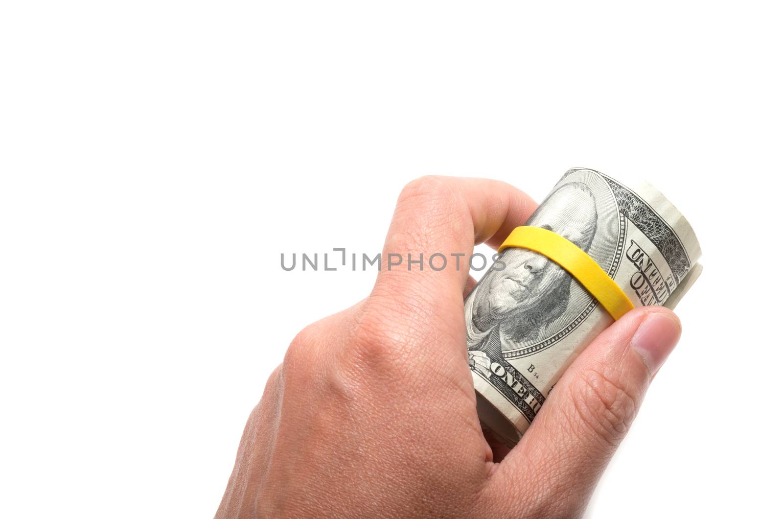 Roll of us bank notes with 100 dollars at the surface, yellow rubber band over the eyes