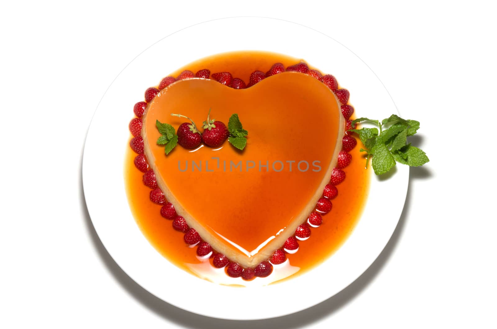 Heart shape flan caramel with strawberries and mint leaves by daoleduc