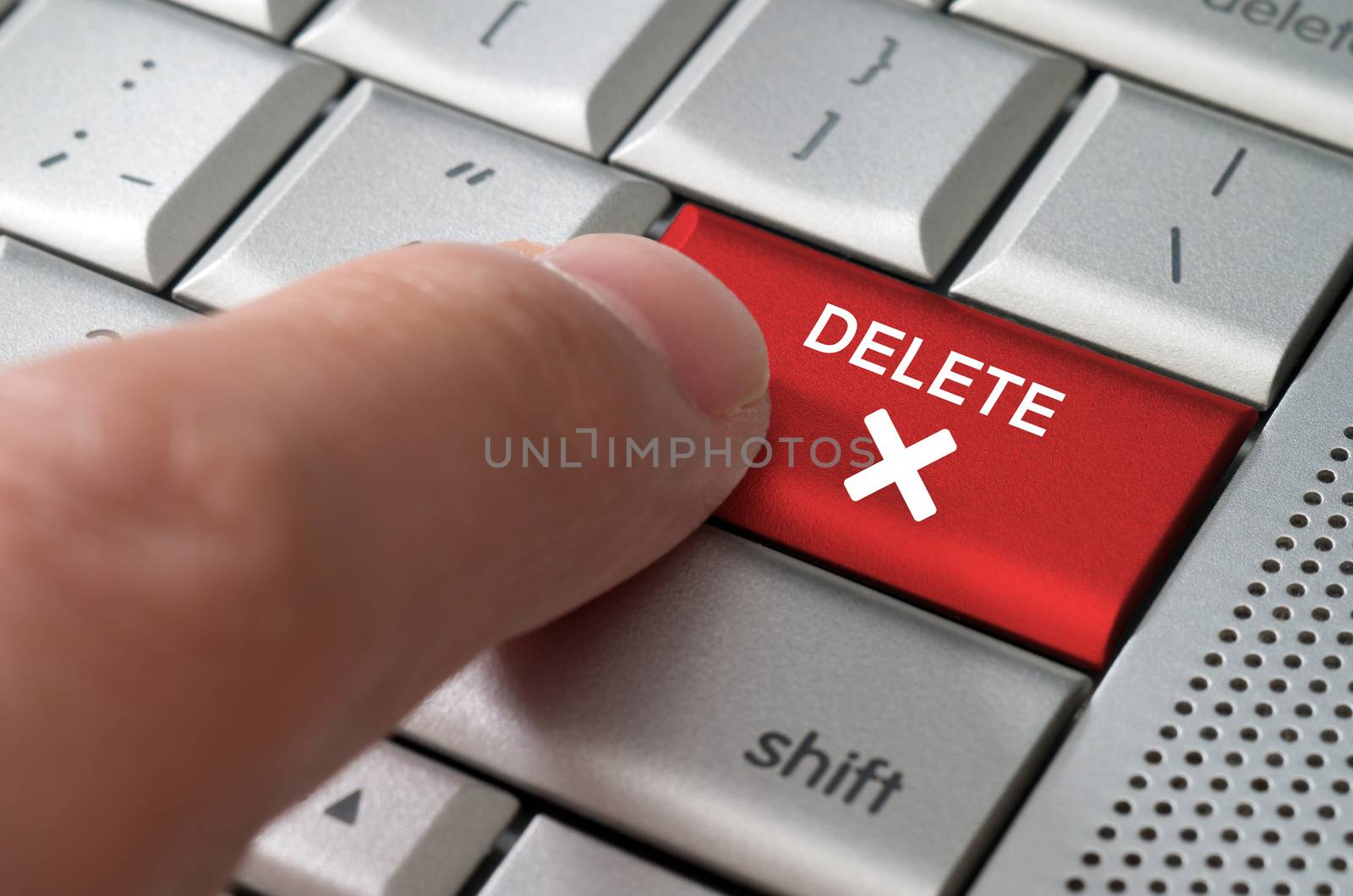 Business concept male finger pointing delete key  by daoleduc