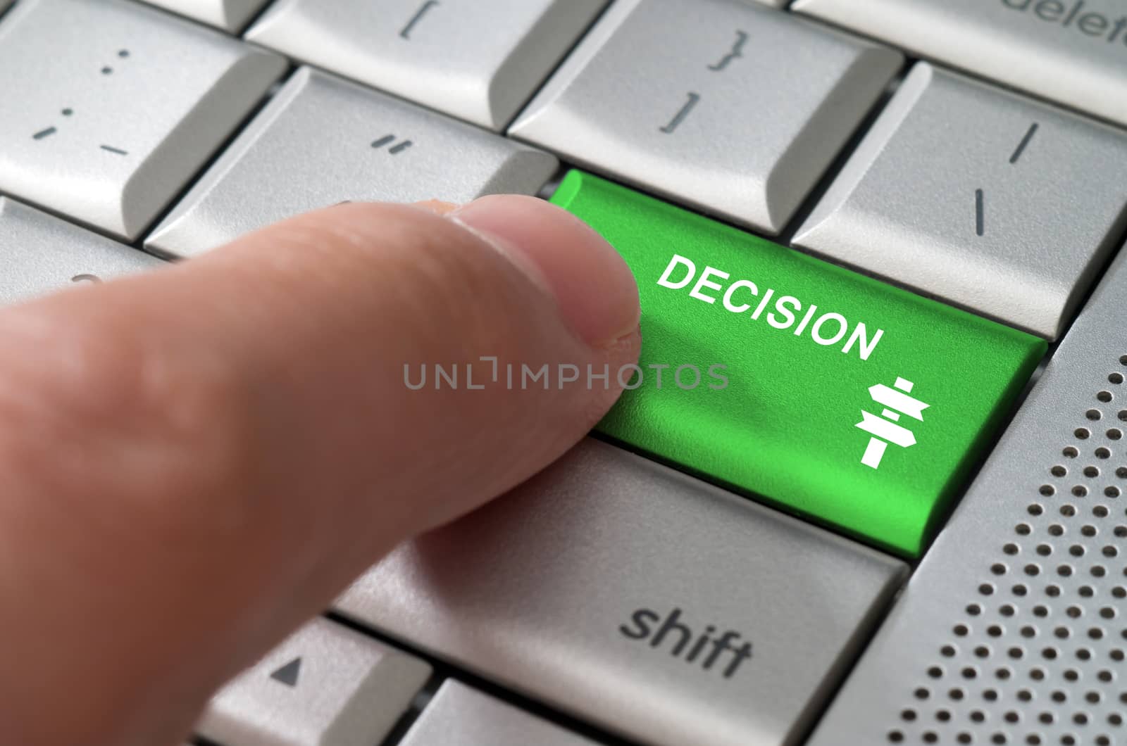 Business concept male finger pointing decision key on  a metallic keyboard