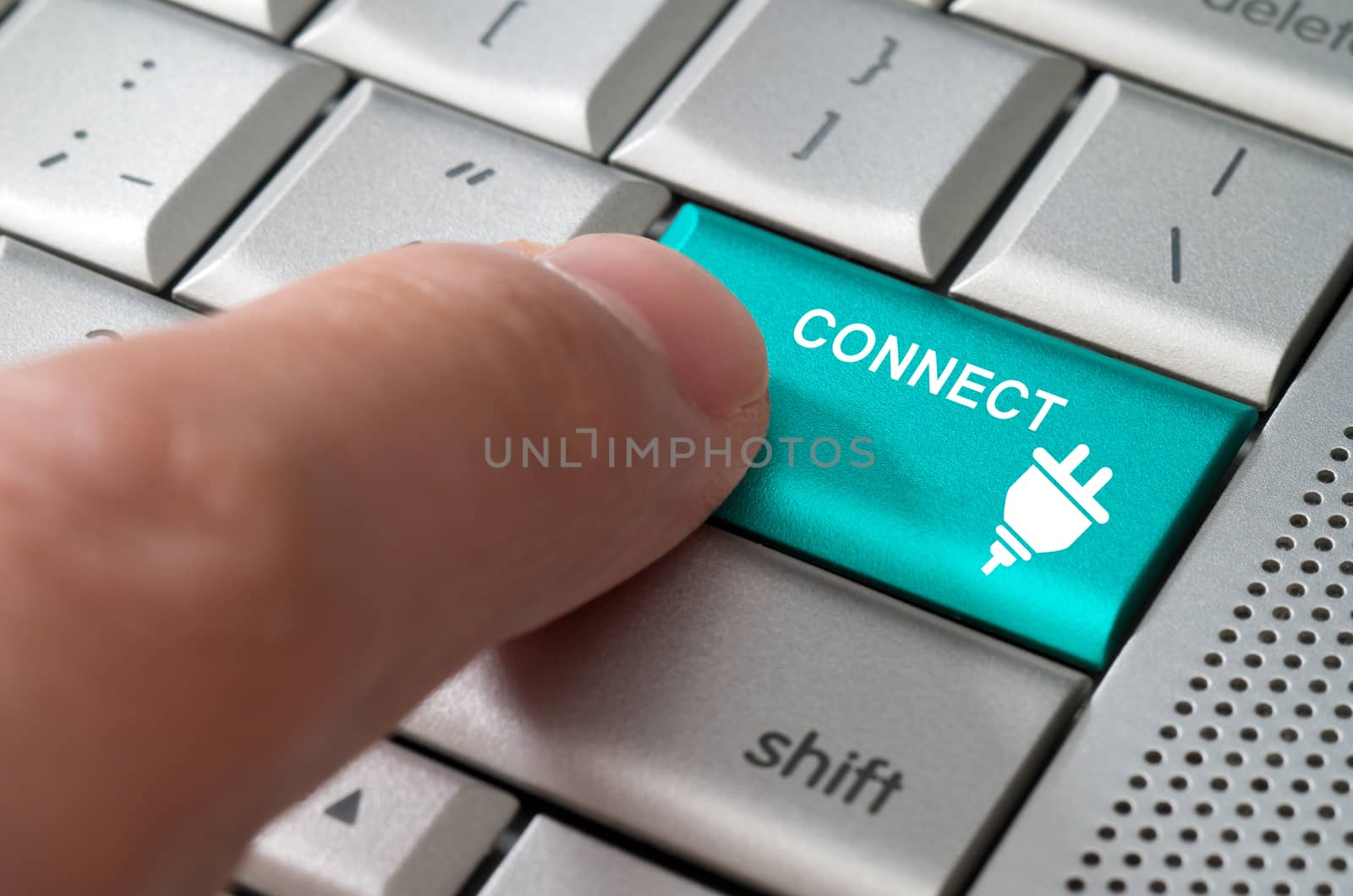 Business concept male finger pointing connect key on  a metallic keyboard