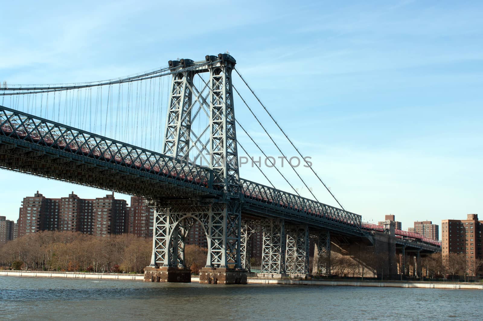 Manhattan bridge viewed from Hudson river during a sunny autumn day