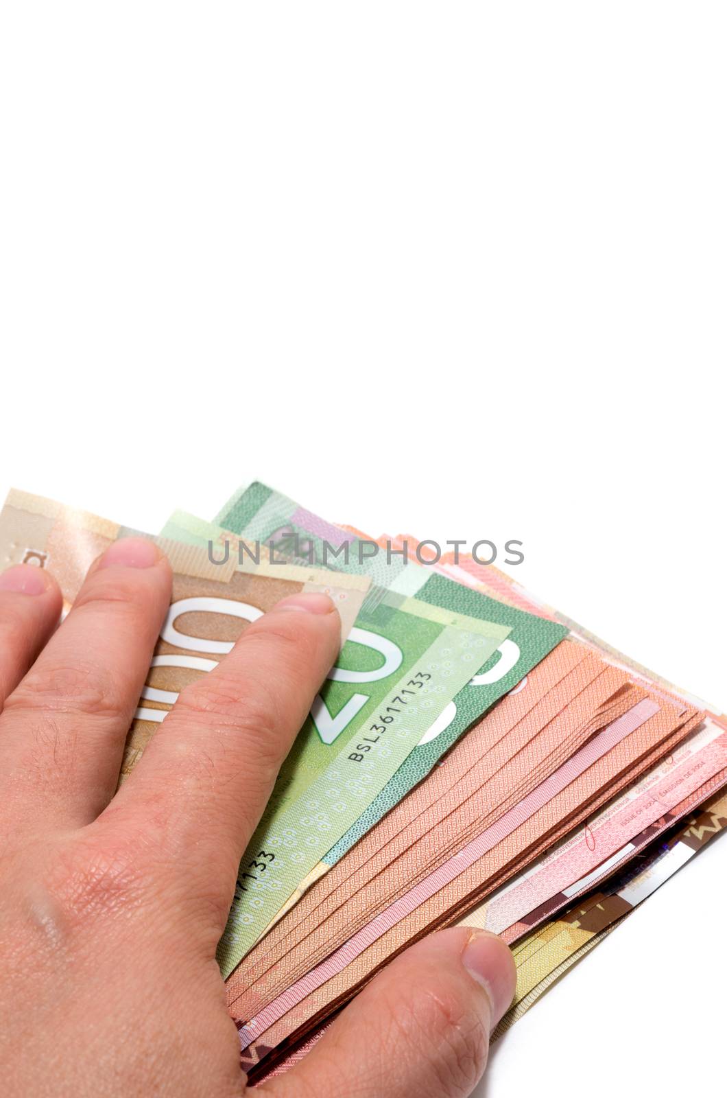 Hand hiding the stash of Canadian banknotes by daoleduc