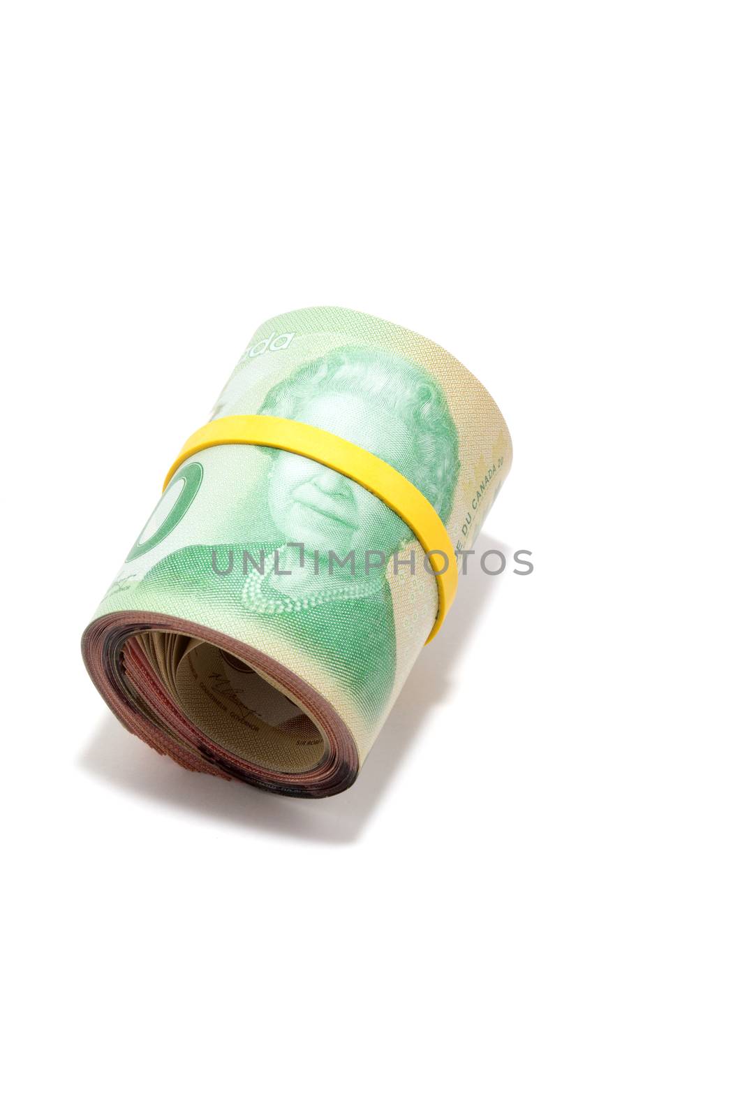 Roll of twenty Canadian dollars isolated on white background by daoleduc