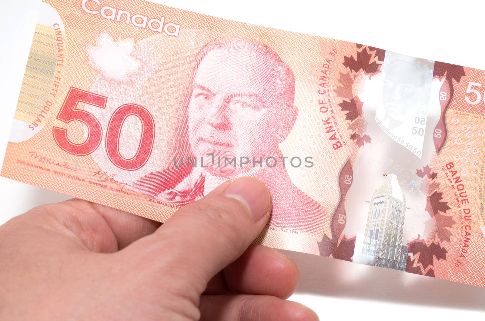 Hand holding 50 Canadian dollars
