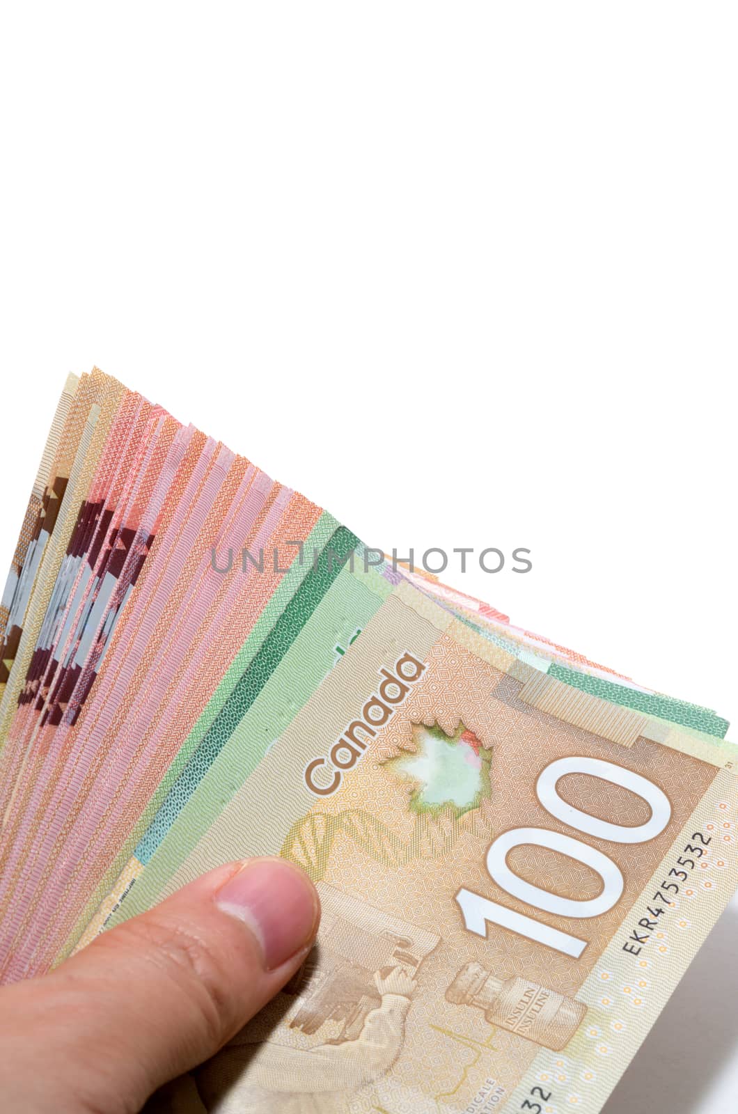Hand holding a series of Canadian banknotes with 100 dollars on  by daoleduc