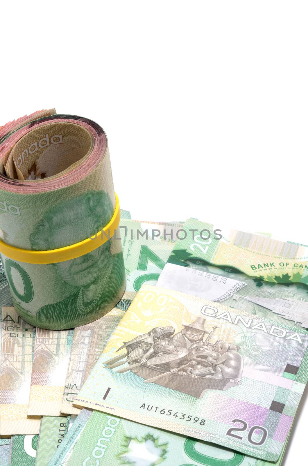 Roll of twenty Canadian dollars isolated on white background