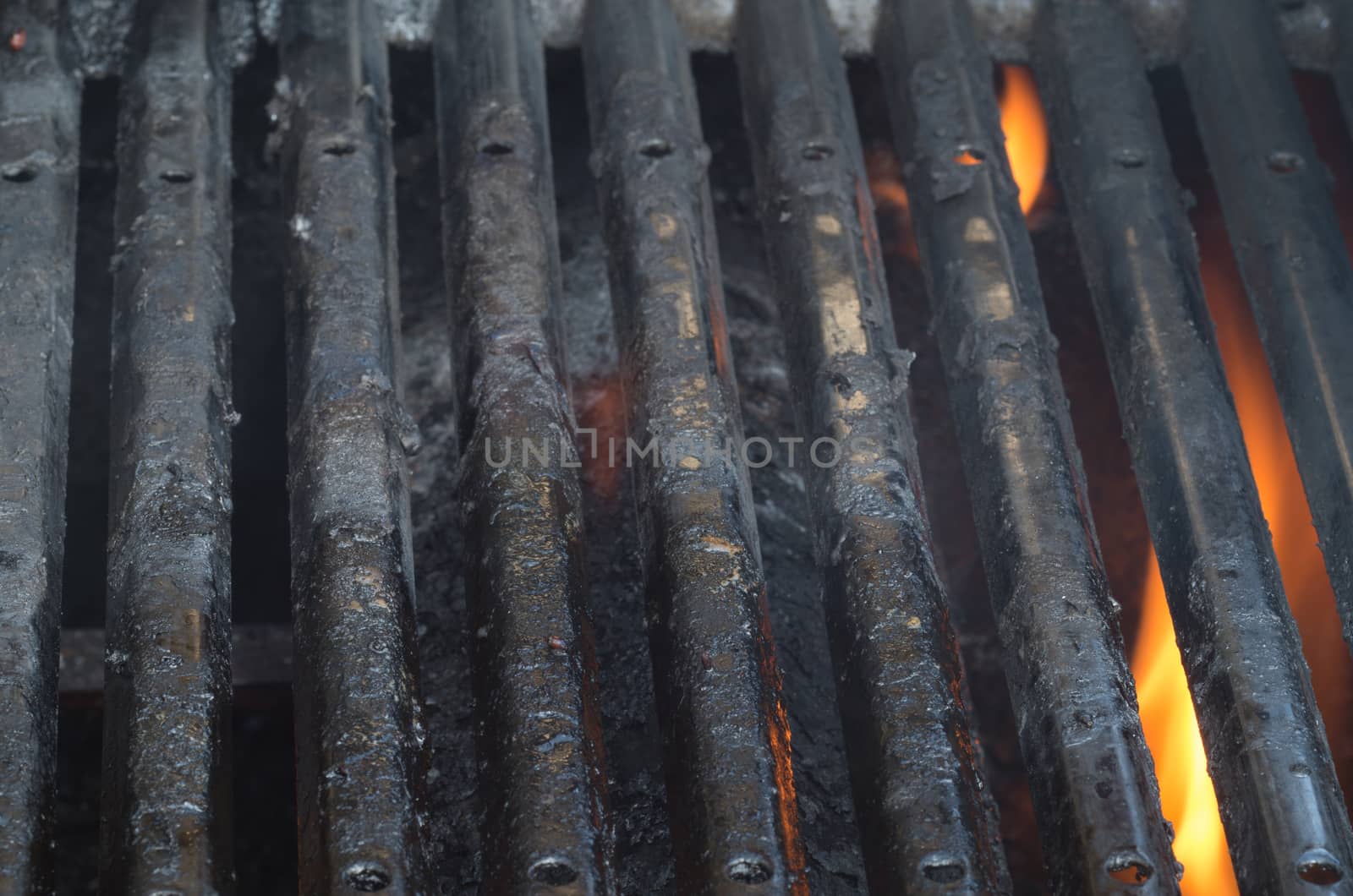 Dirty barbecue grills and flames
