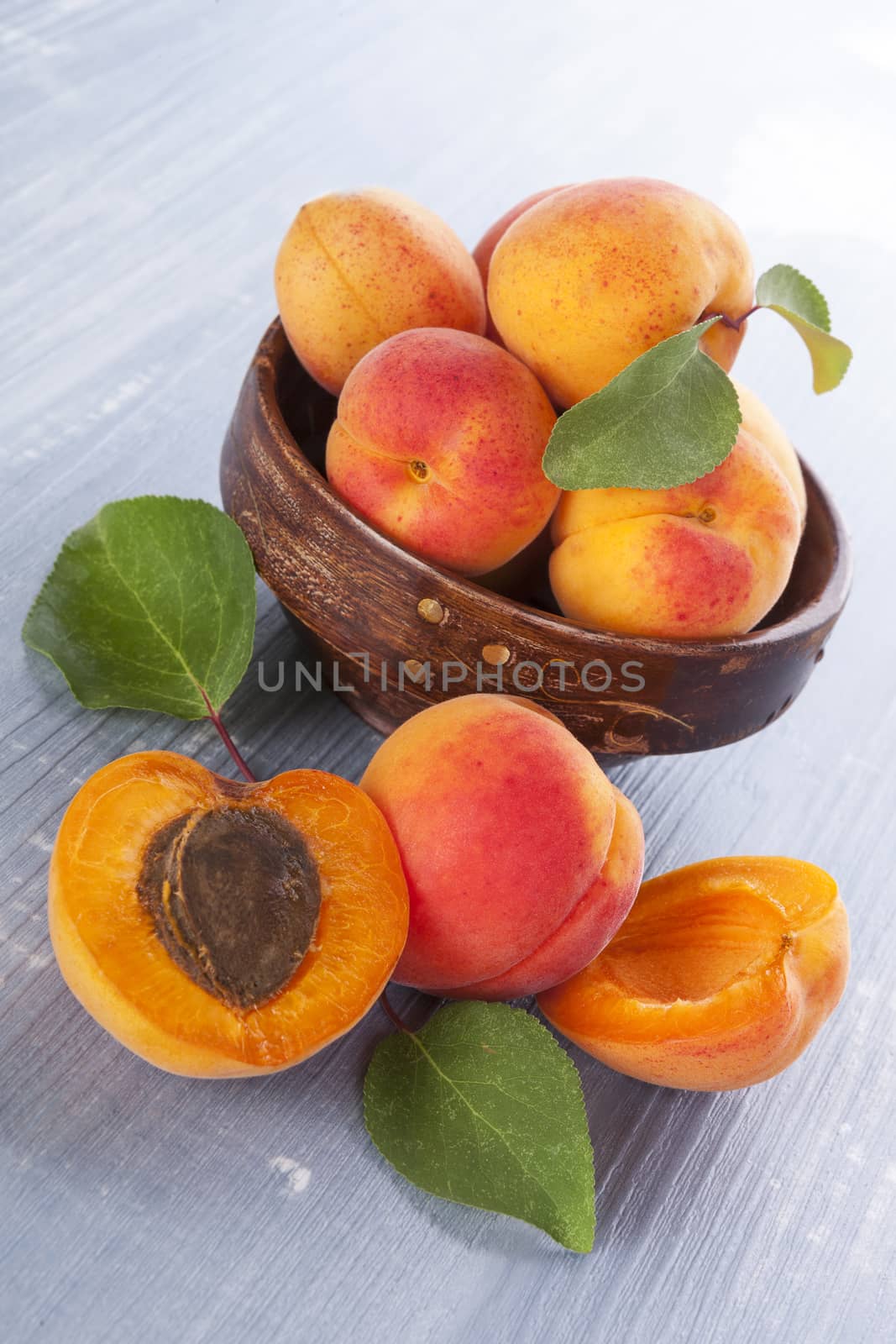 Fresh delicious apricots on wooden background. Fresh summer fruits, rustic styles.