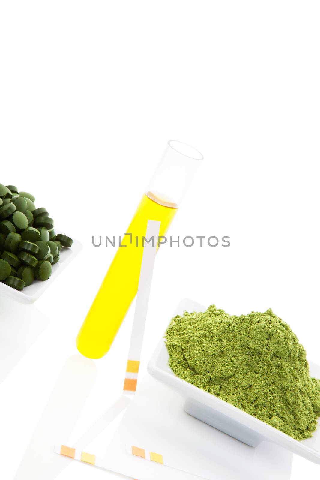 Superfood. Wheat grass, chlorella and spirulina pills and ground with urine sample and ph tester. 