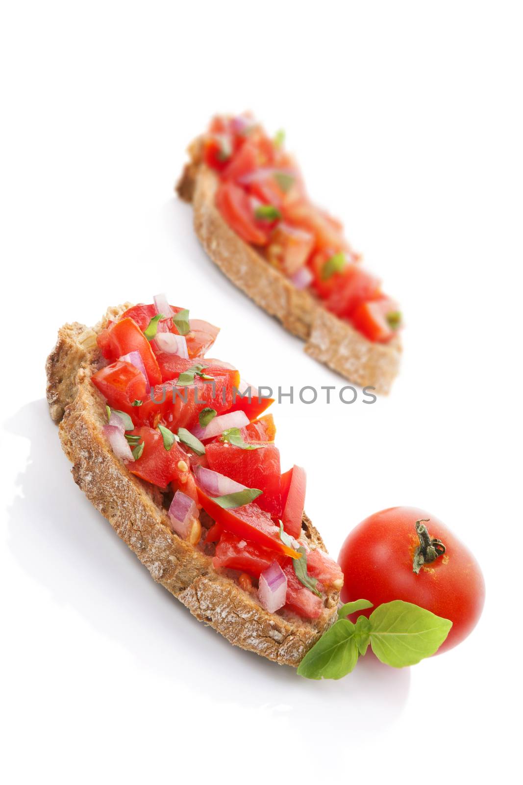 Delicious bruschetta with fresh tomato and basil herb isolated on white background. 