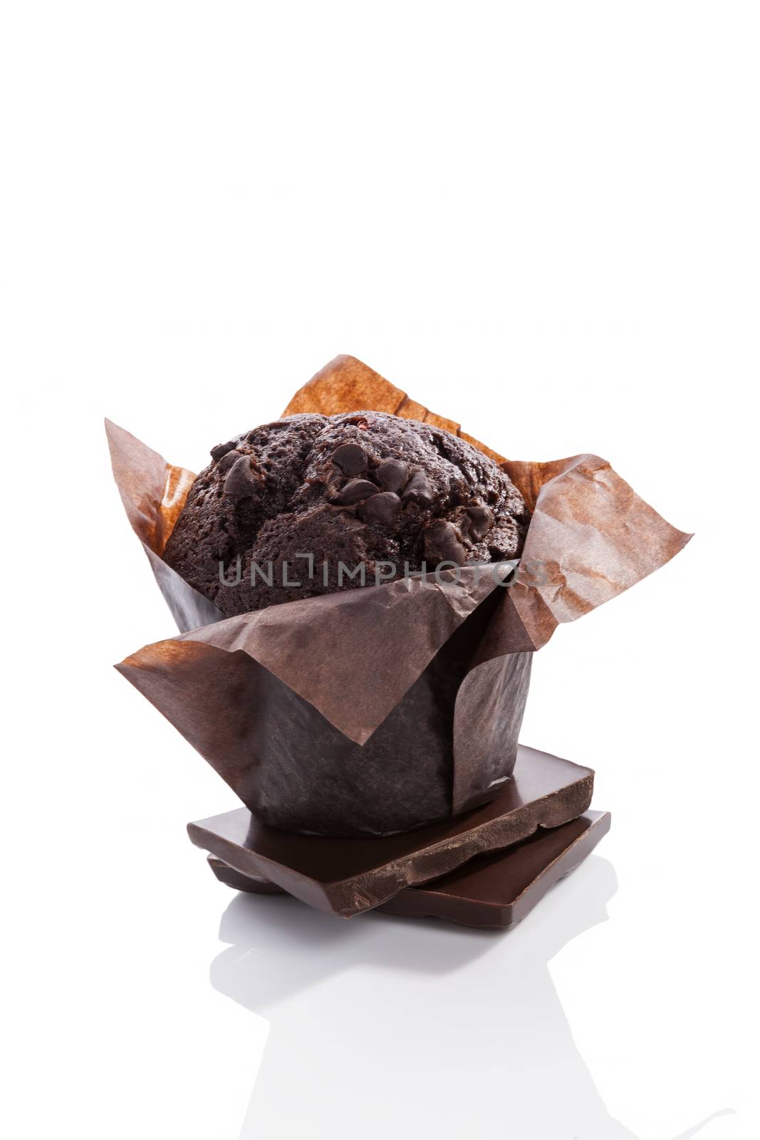 Chocolate muffin isolated on white background with reflection. Culinary sweet dessert eating. 