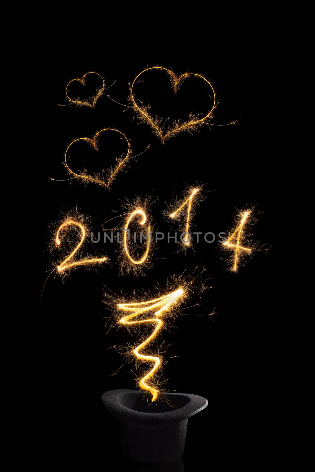 Magical happy new year. Magical fireworks from black top hat forming digits 2014, heart shapes and abstract light lines isolated on black background. Happy new year background.