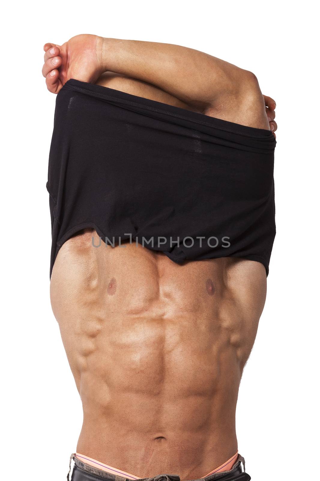 Muscular sexy young man taking off t shirt isolated on white background. Sexy stripper undressing.