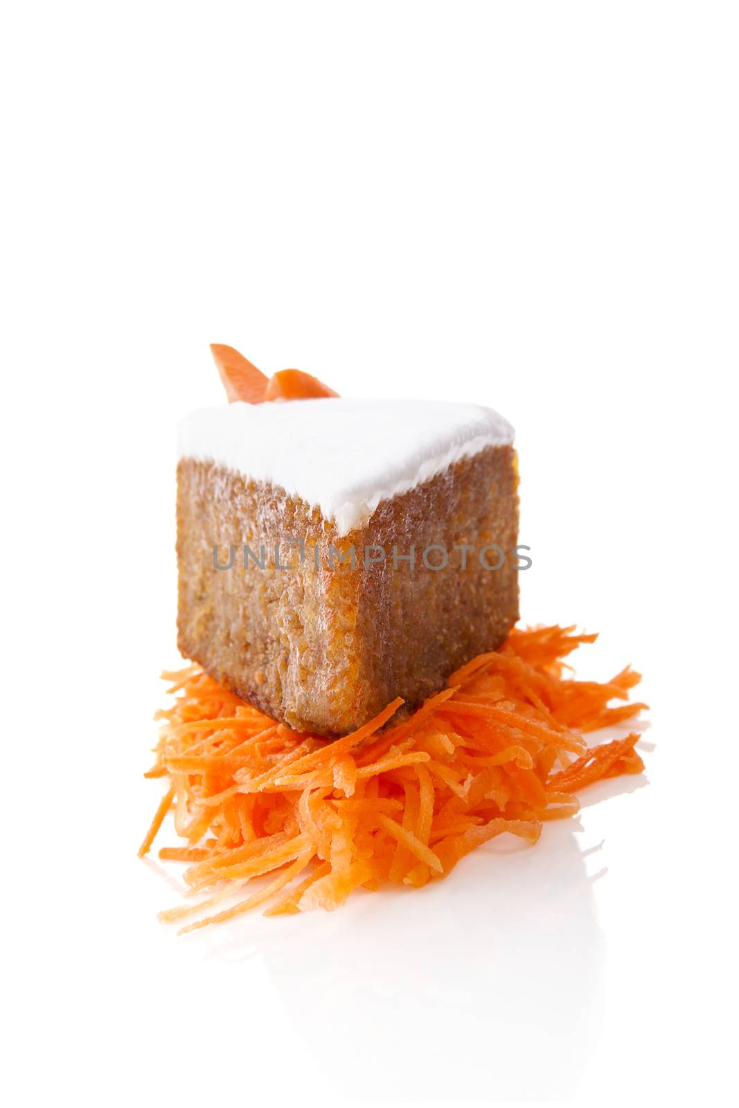 Delicious carrot cake on grated carrots isolated on white background. Culinary sweet dessert.