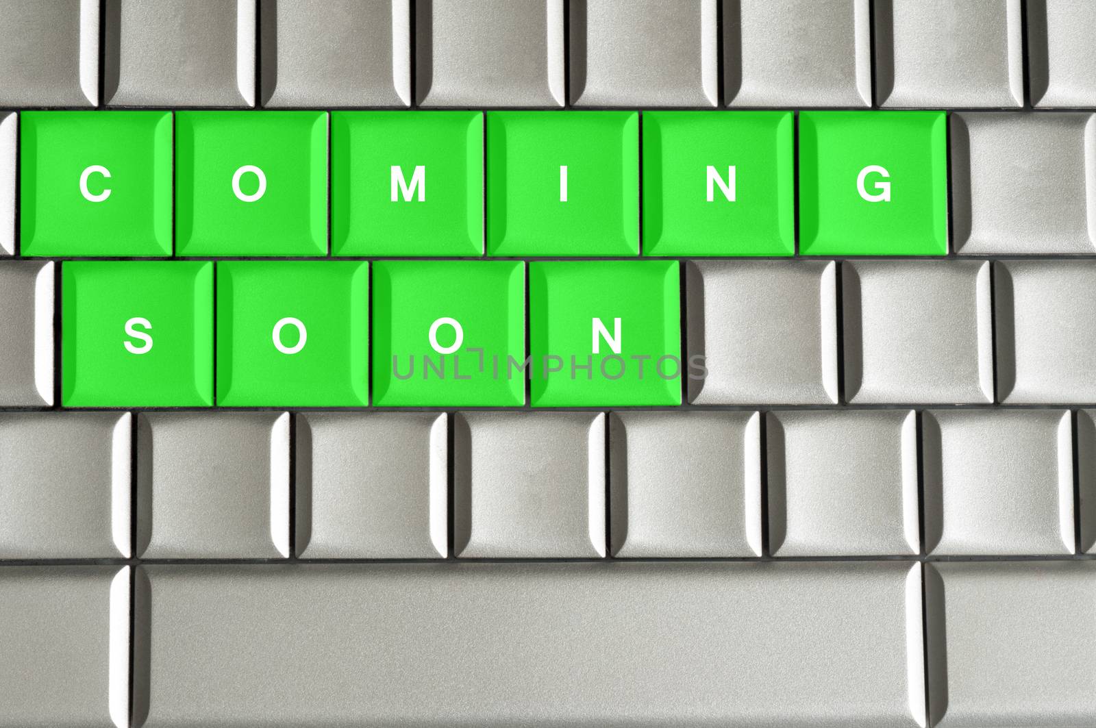 Coming Soon spelled on a silver metallic keyboard