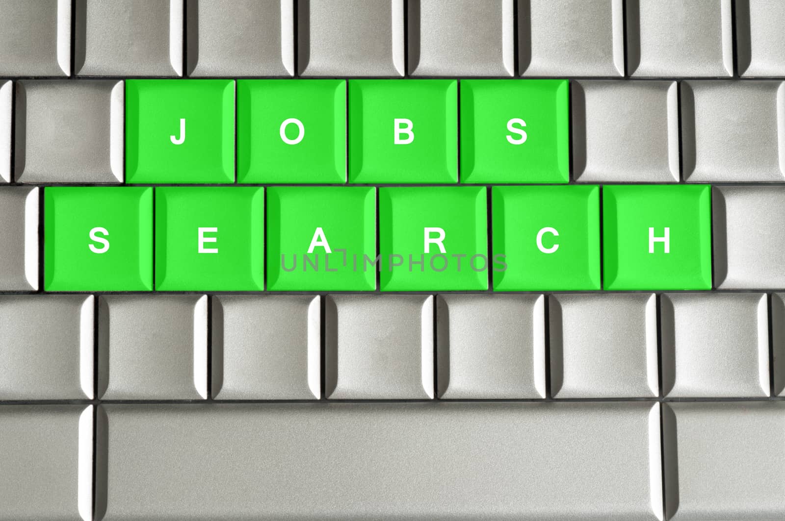 Jobs search spelled on a silver metallic keyboard