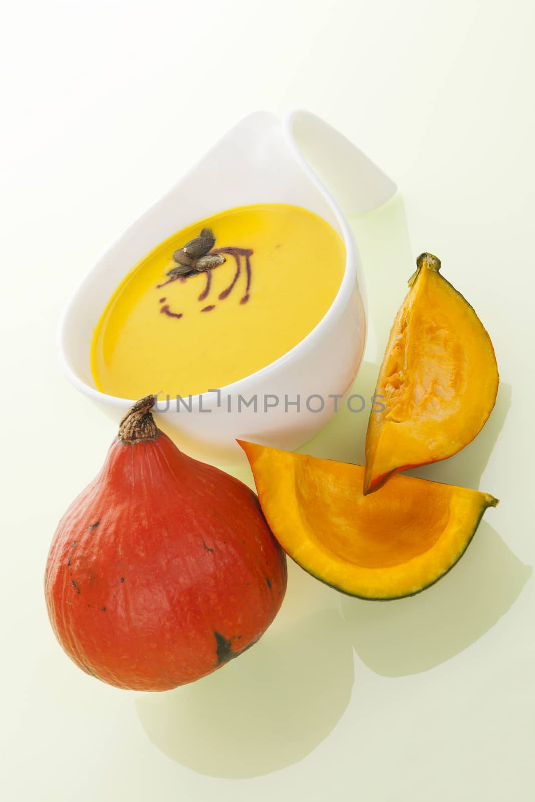 Culinary delicious hokkaido soup with fresh hokkaido pumpkin isolated on yellow background. Culinary soup eating. 