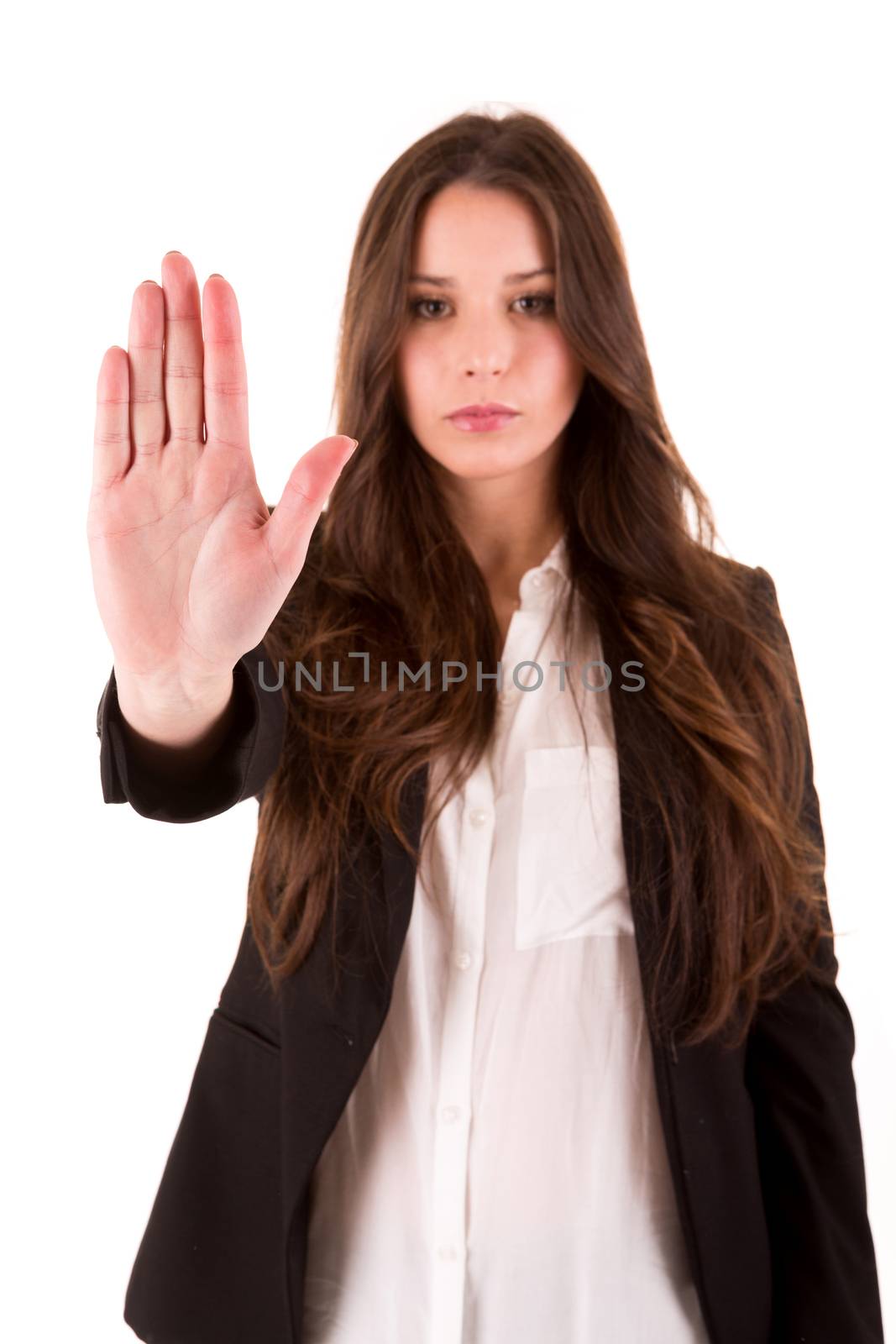 Smiling woman doing STOP sign - selective focus on hand