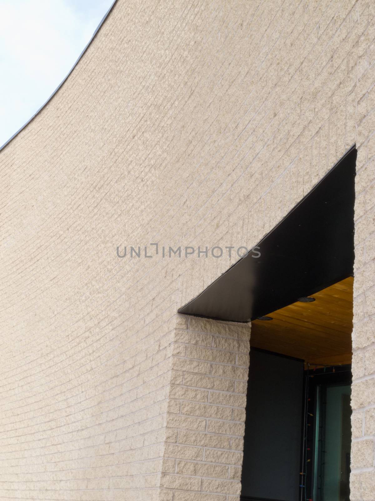 Empty curved masonry exterior wall and entrance opening building architecture