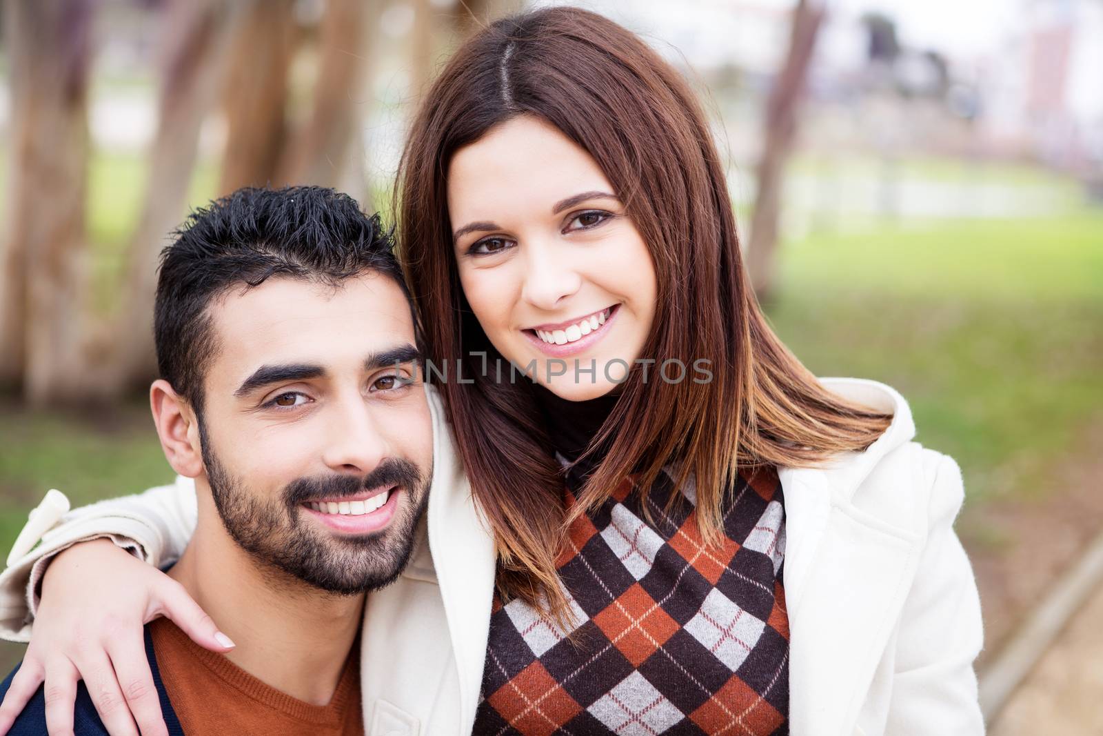 Young romantic couple on a bench in park