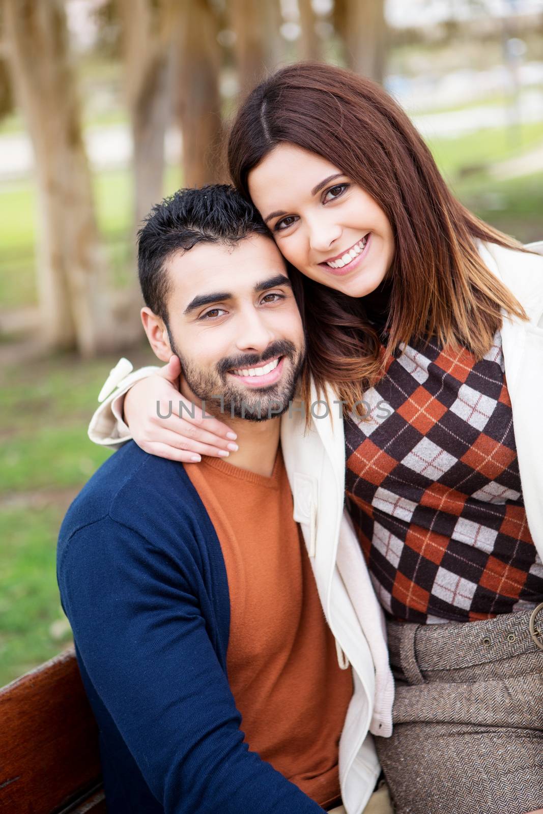 Young romantic couple on a bench in park