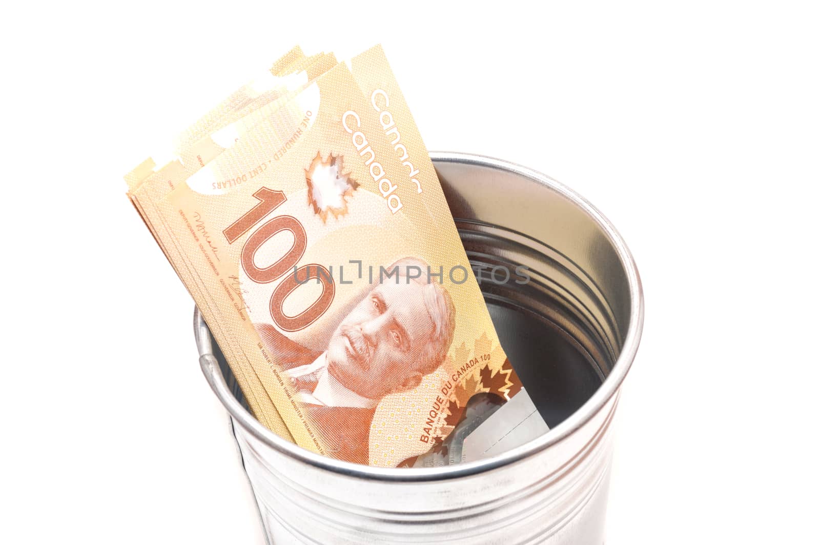 Hundred Canadian dollar bills in an aluminium  pot