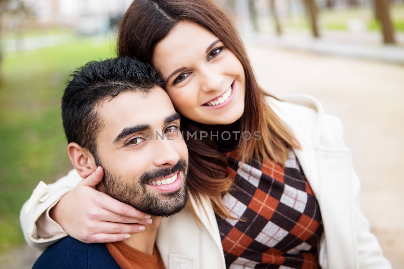 Young romantic couple on a bench in park