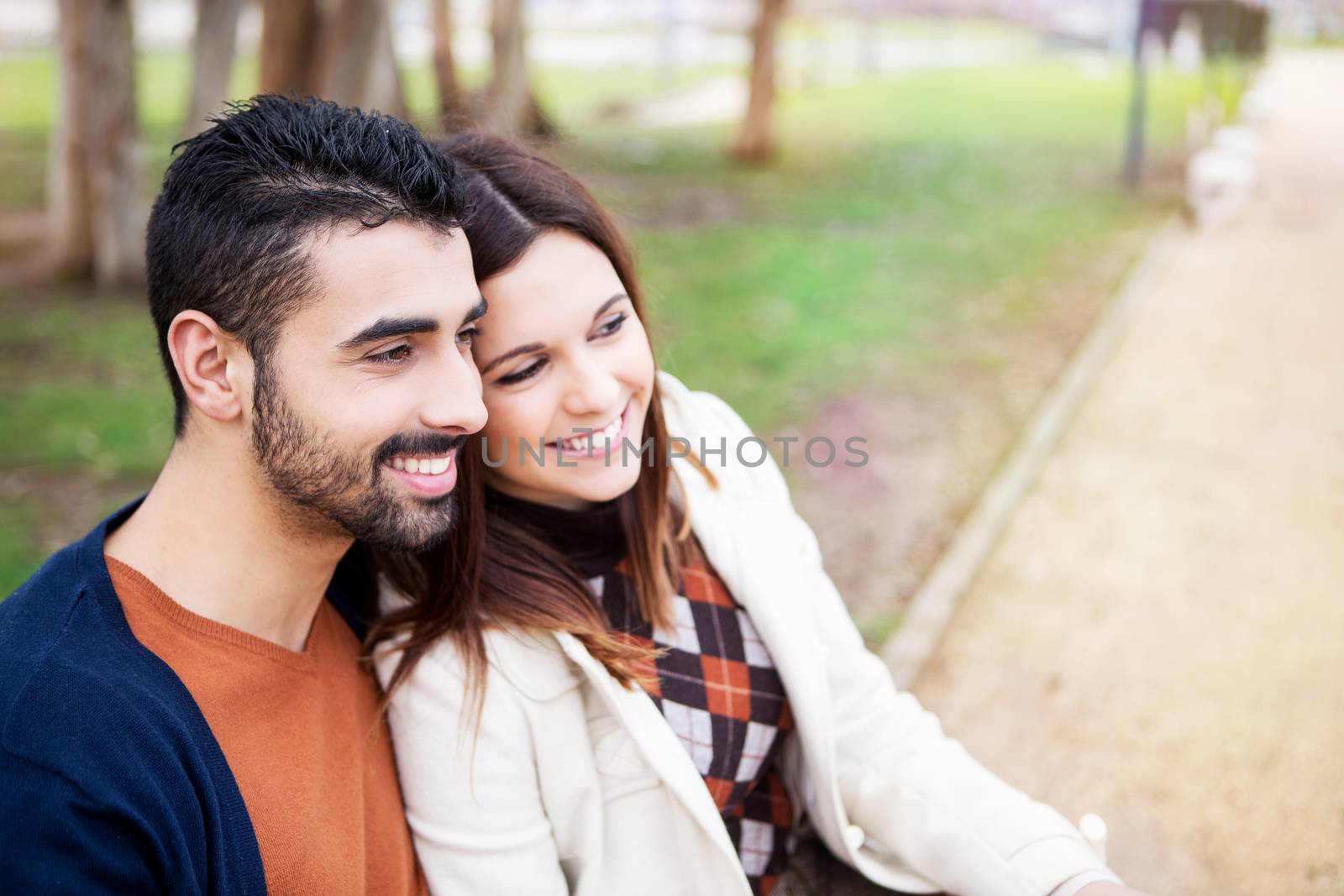 Young romantic couple on a bench in park