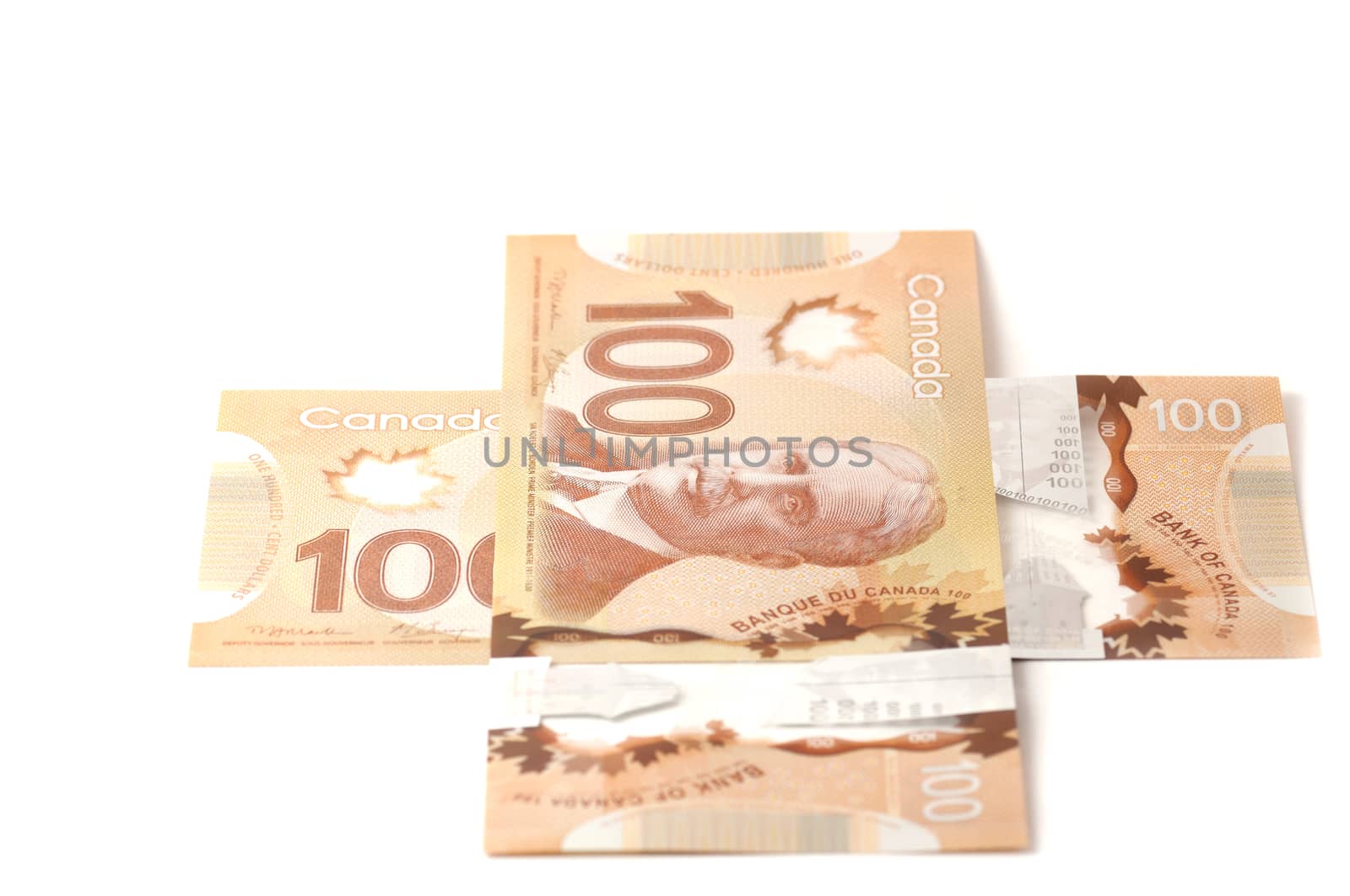 Two hundred Canadian dollar bills in a plus sign isolated on white backhround