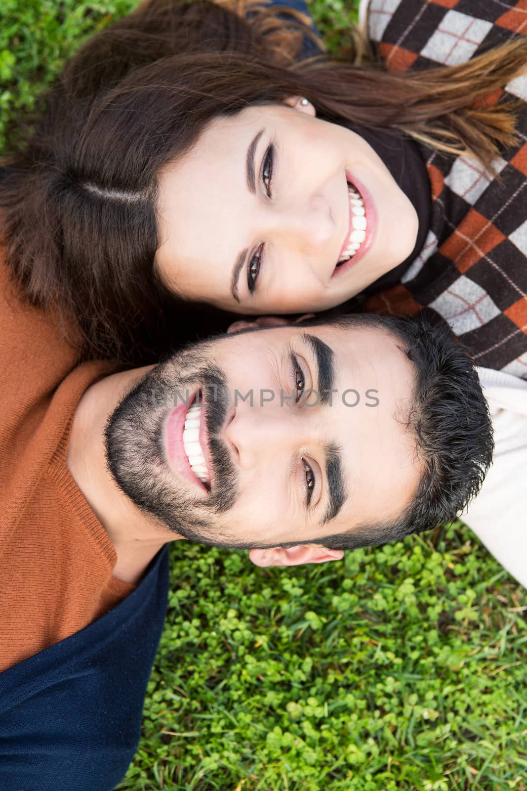 Happy couple relaxing on the grass park