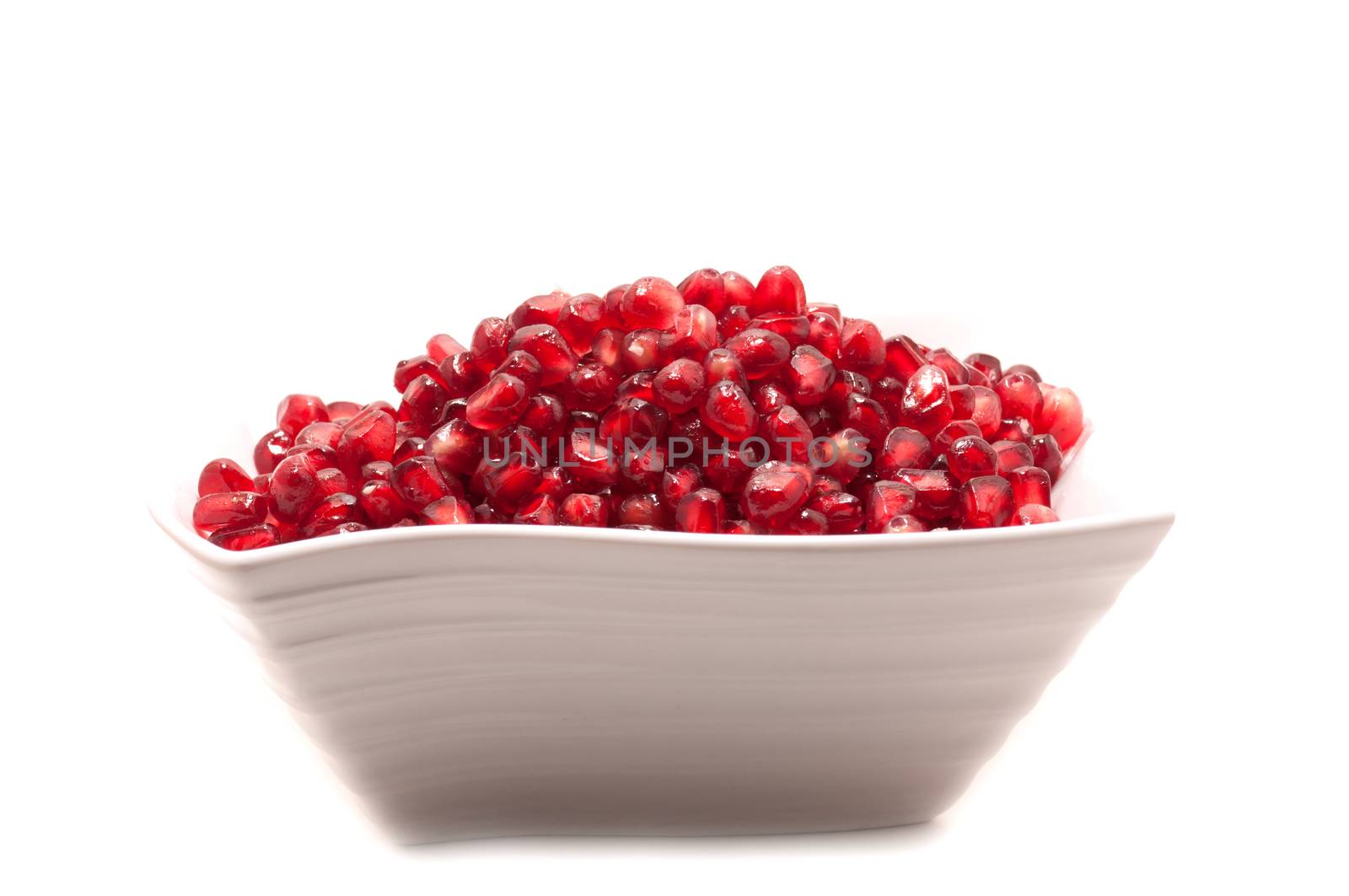 Pomegranate seeds close-up with frost