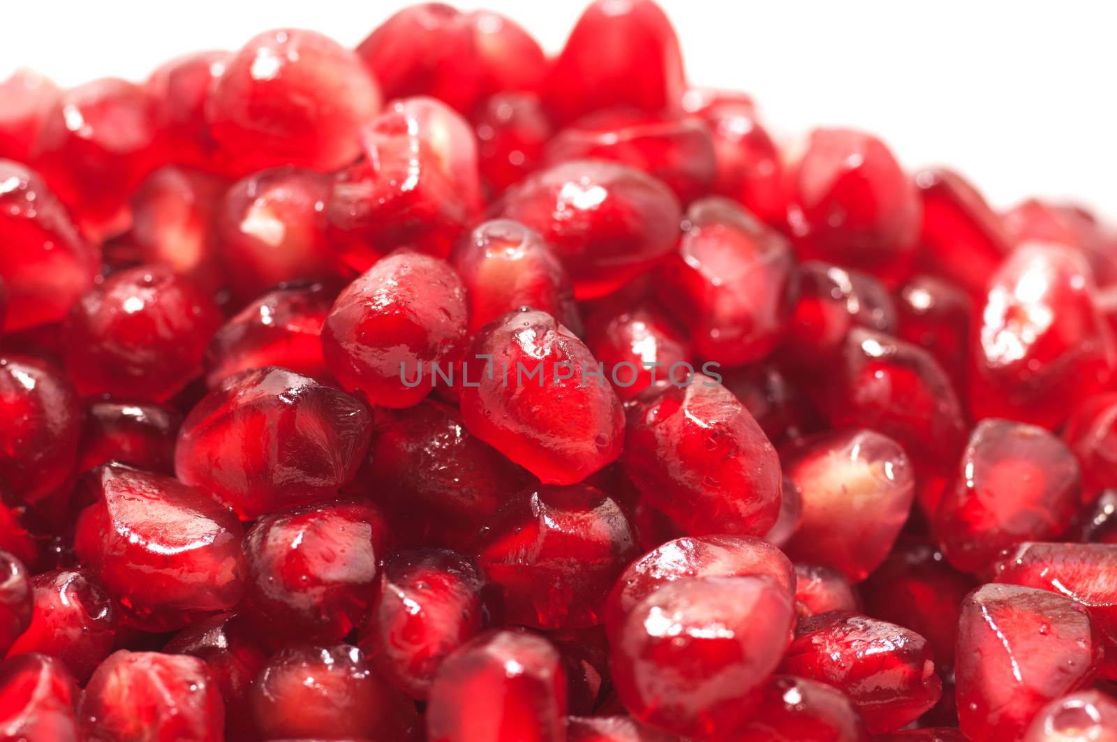 Pomegranate seeds close-up with frost