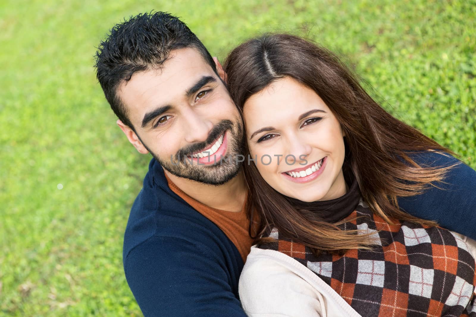 Happy couple relaxing on the grass park