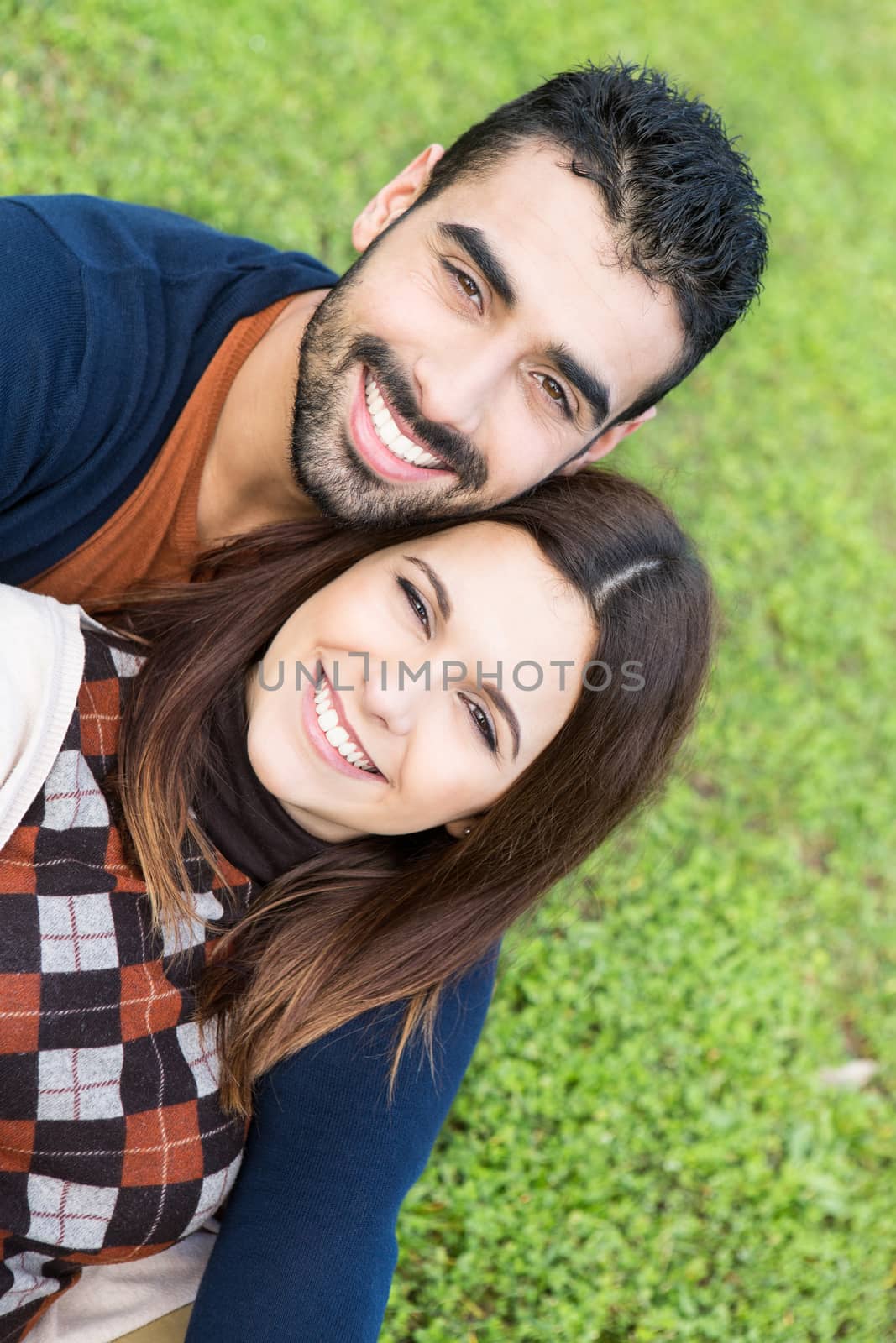 Couple lying in grass by jolopes