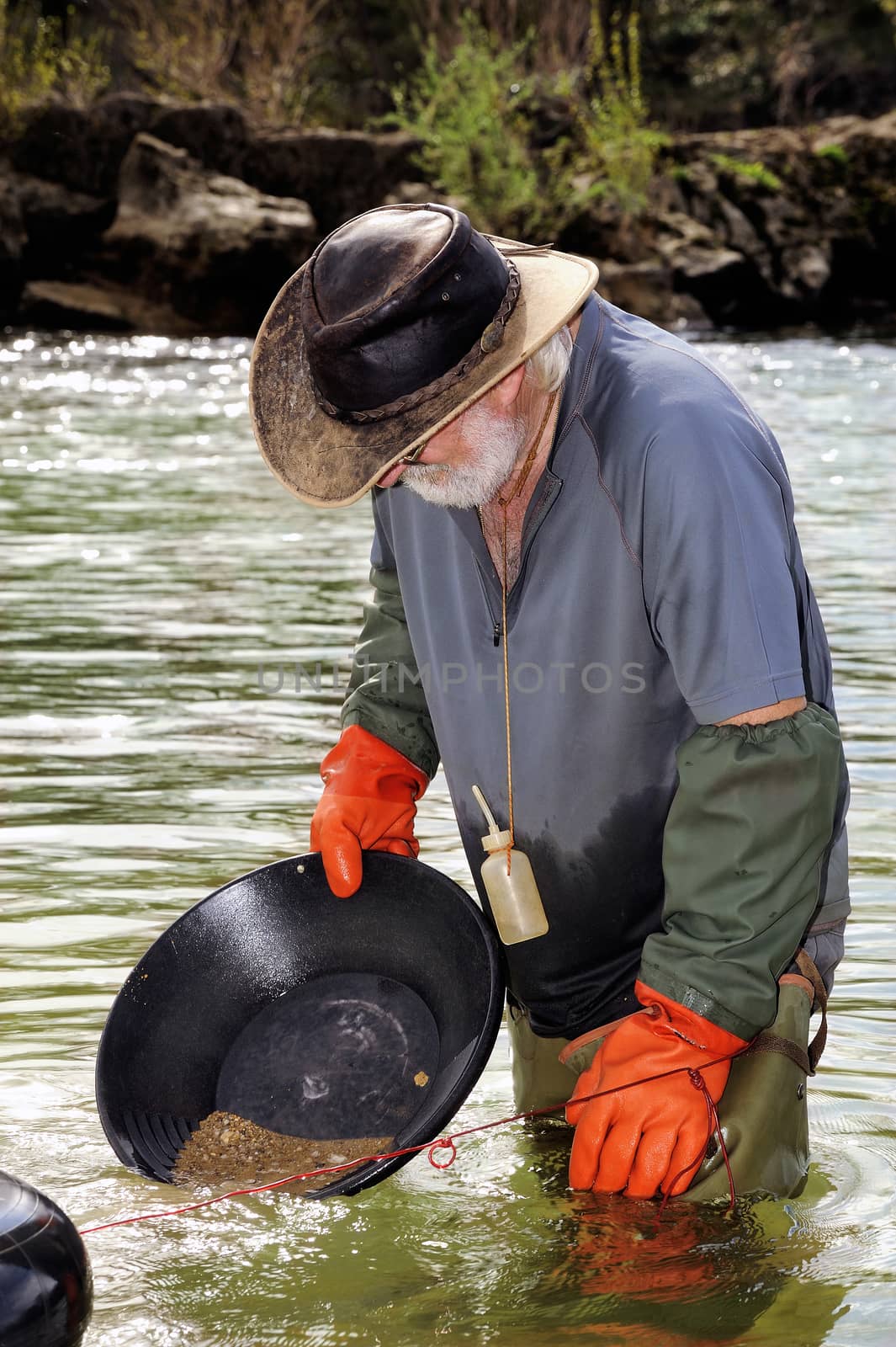 Gold digger in France in the region of Cevennes and the department of Gard in the middle of the river called Le Gardon.