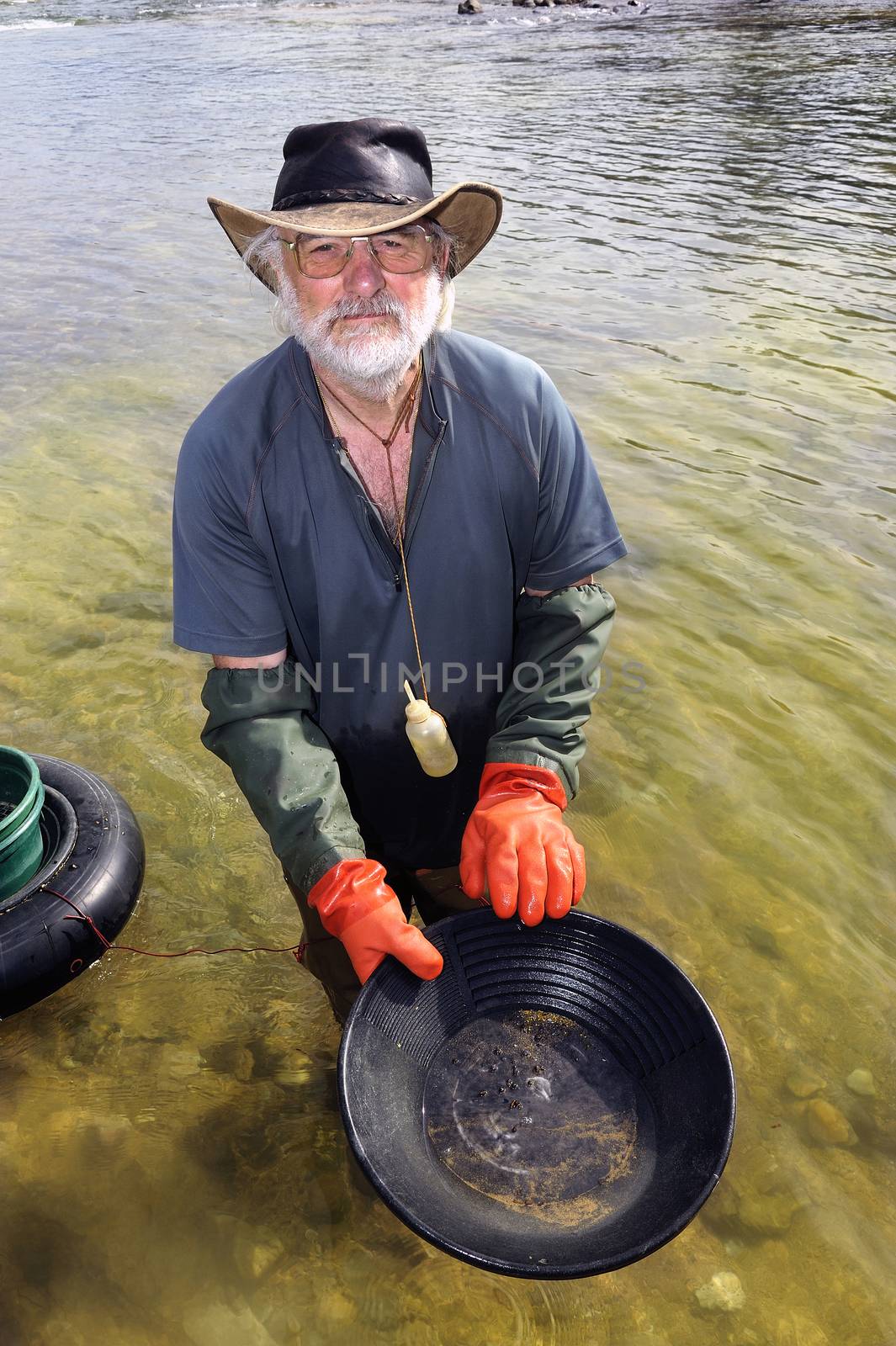 Gold digger in France in the region of Cevennes and the department of Gard in the middle of the river called Le Gardon.