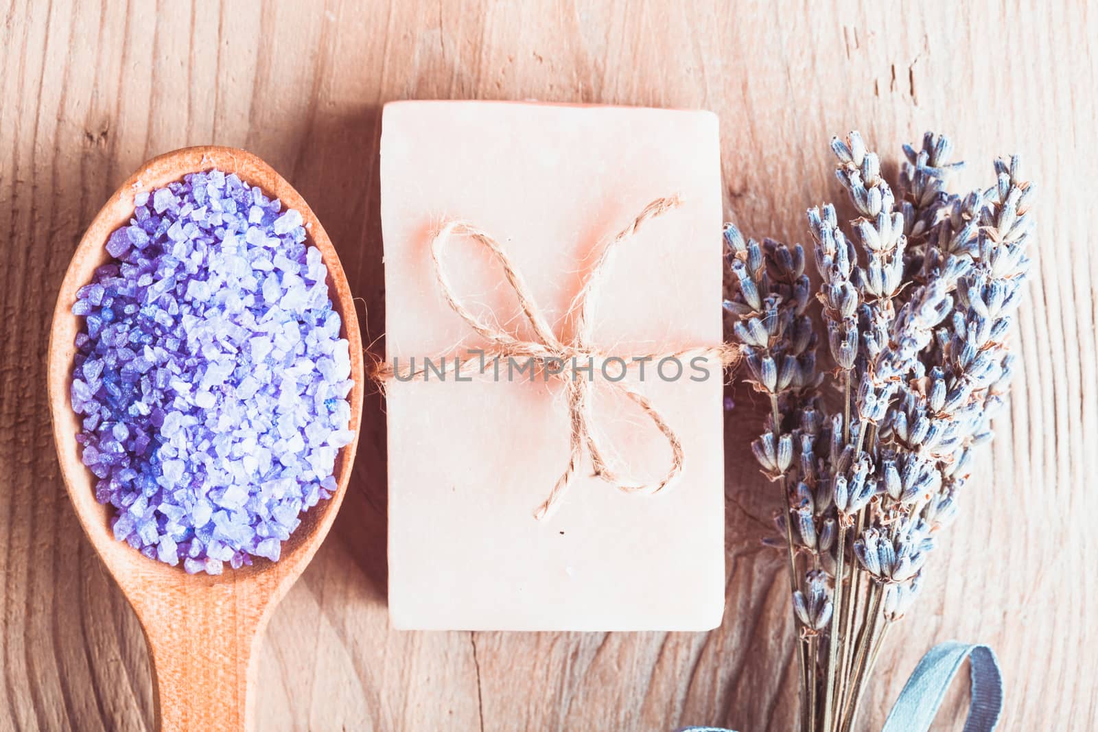 Lavender treatment soap and sea salt on wooden table